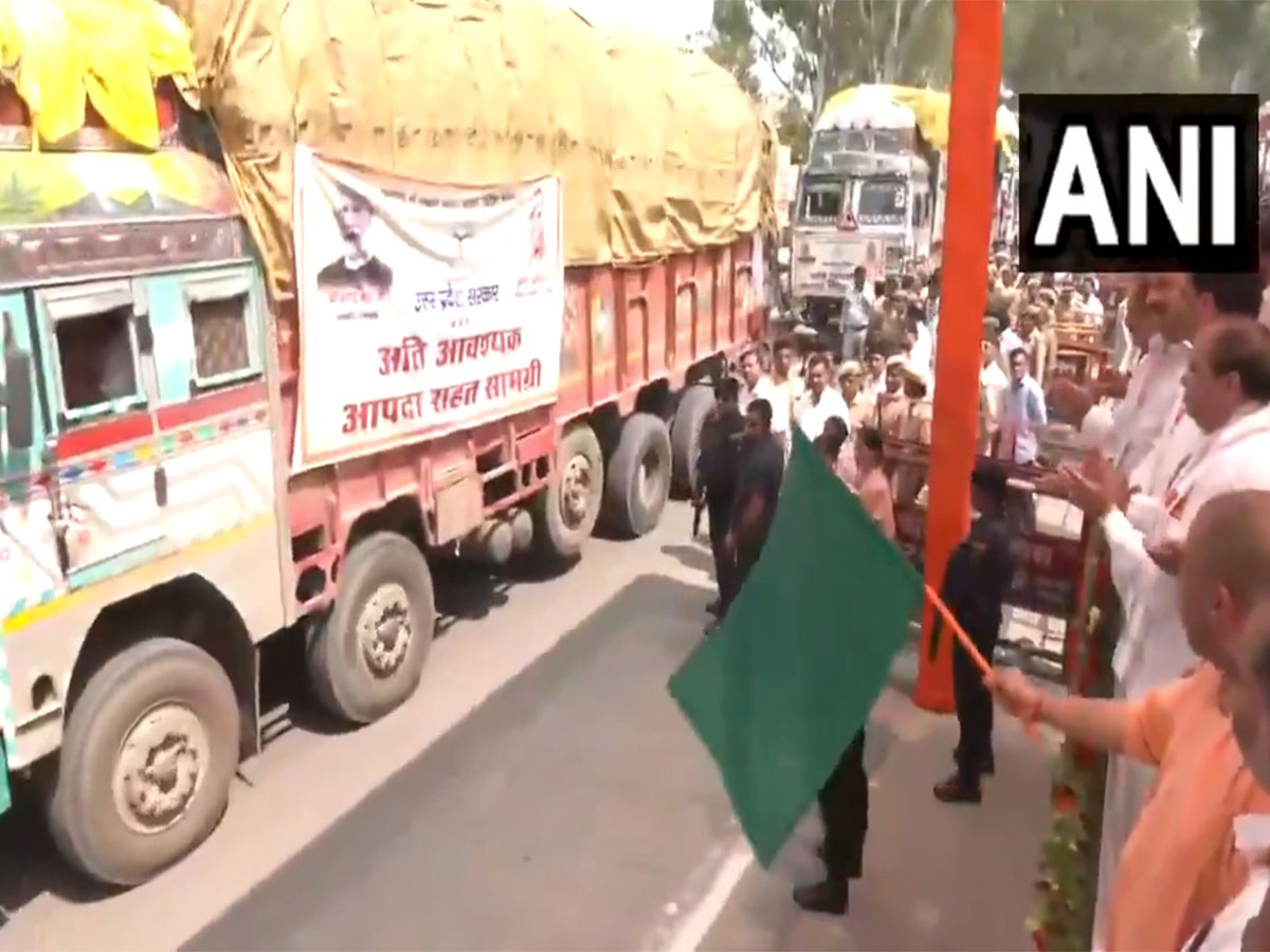 UP CM Yogi flags of 48 trucks of relief materials to flood-affected states (Photo/ANI) 