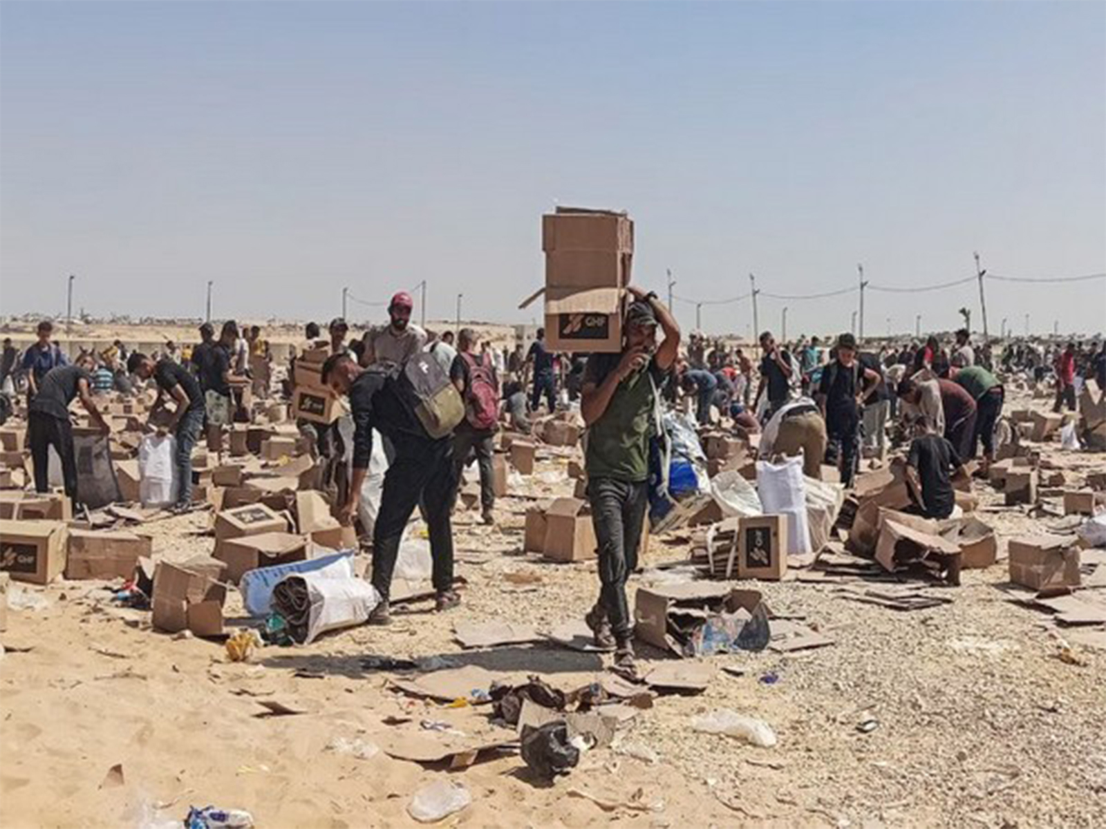 Palestinians gather to collect relief supplies from the US-backed Gaza Humanitarian Foundation’s distribution centre in Rafah, southern Gaza Strip (File Photo/Reuters)