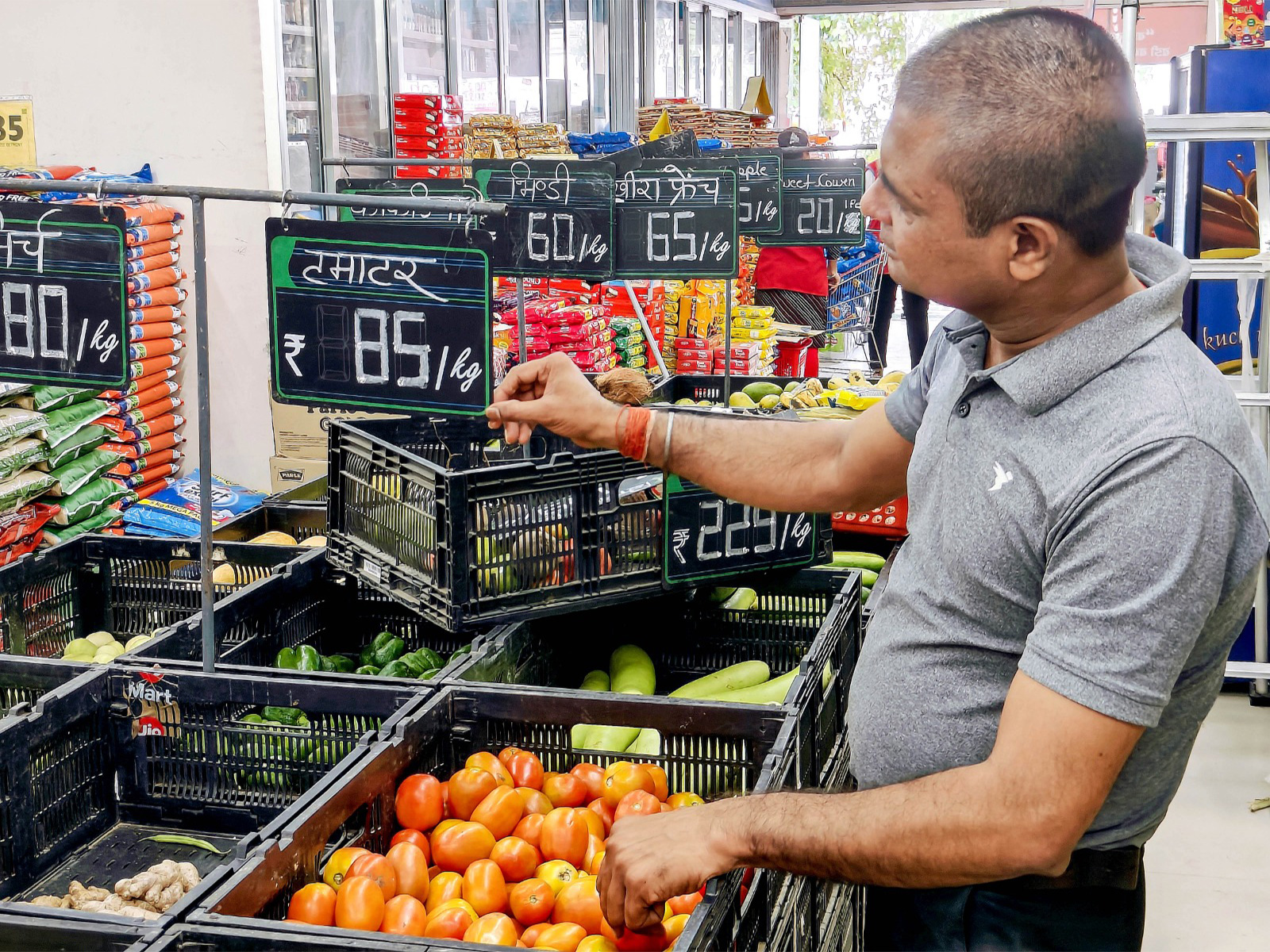 A salesman updates the price tag (File Photo/ANI)
