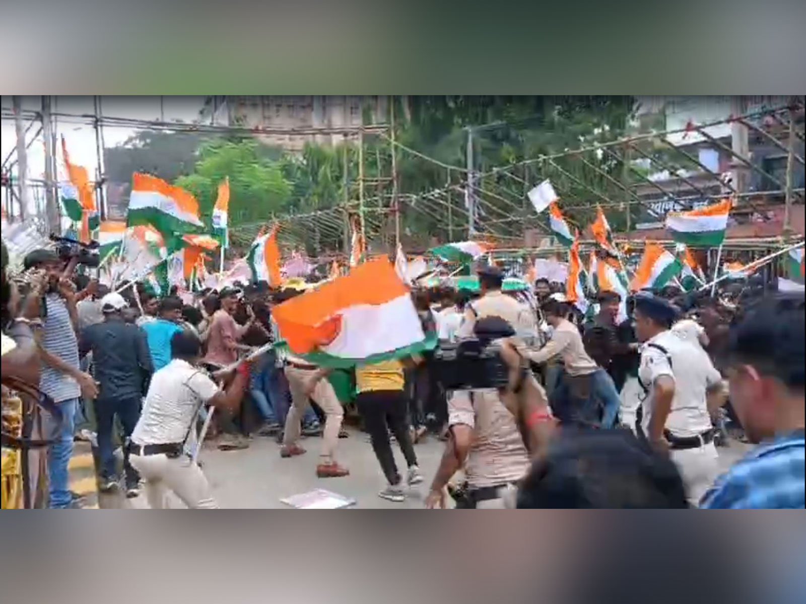Visual of Bihar police official swinging national flag at protesting students (Photo/ANI)