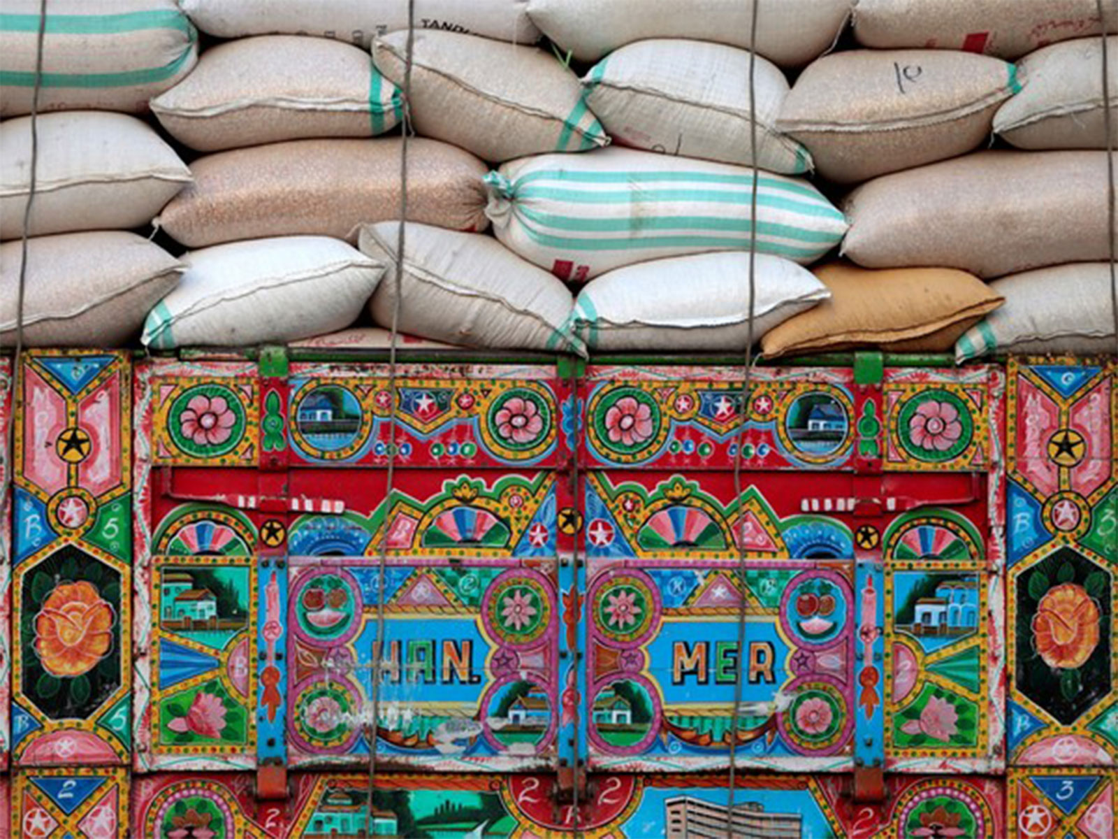 Wheat sacks loaded on a truck in Pakistan amid movement restrictions causing flour shortages in other provinces (File Photo/Reuters)