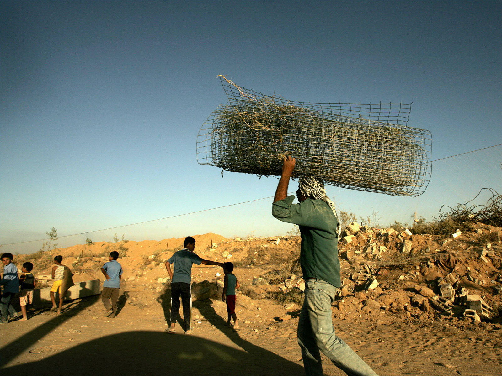 Palestinians collect valuables from the former Jewish settlement of Kfar Darom in Gaza strip. (Photo/Reuters)