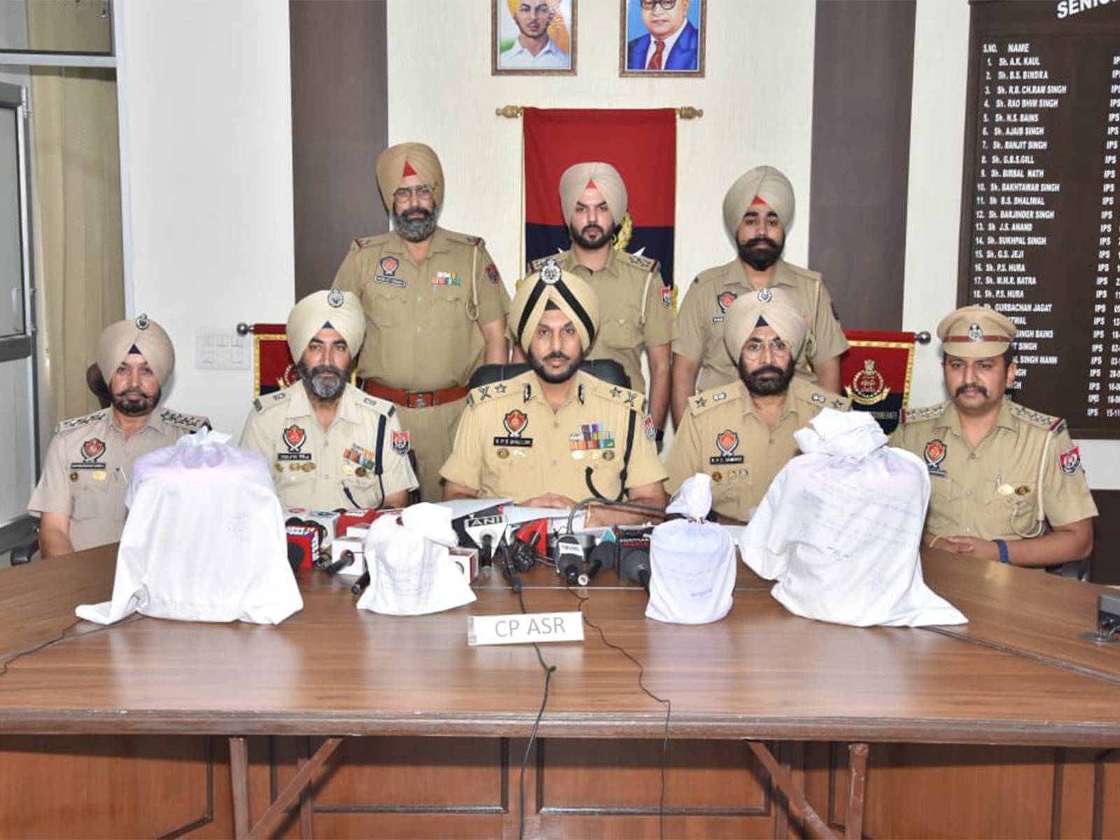 Punjab police with recovered heroin. (Photo/ANI)