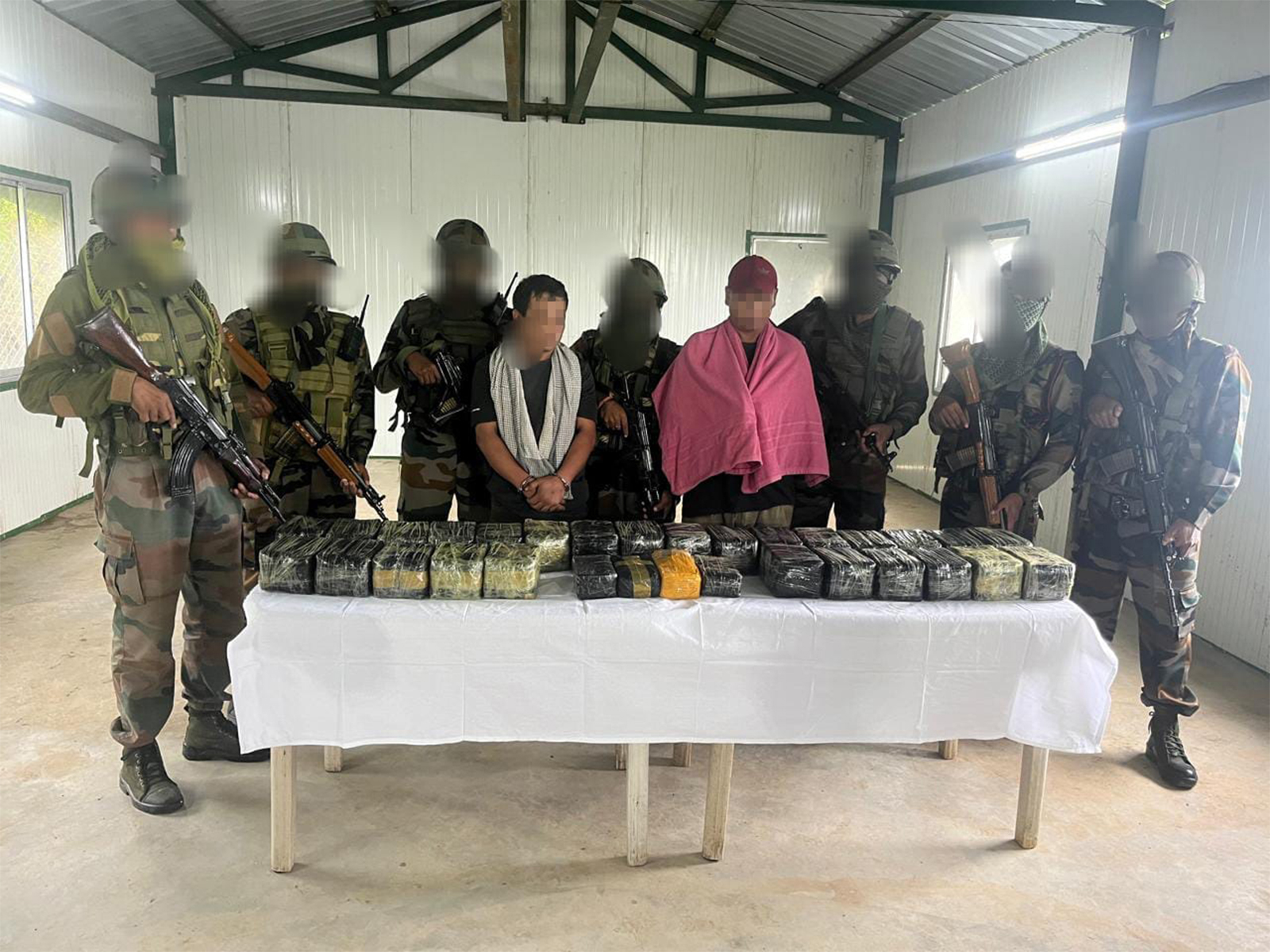 Officials with seized narcotics and apprehended officials (Photo/Assam Rifles) 
