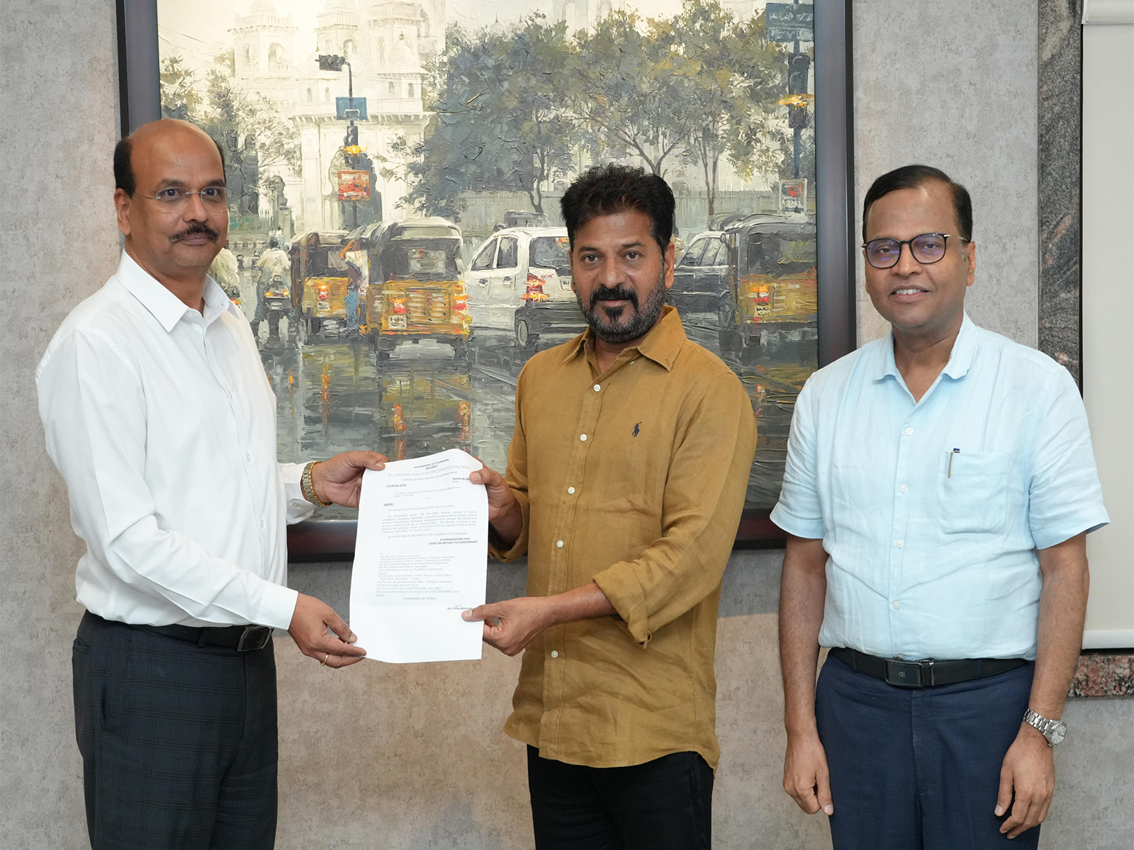 Telangana CM Revanth Reddy hands over appointment orders to B Shivadhar Reddy. (Photo/ANI)