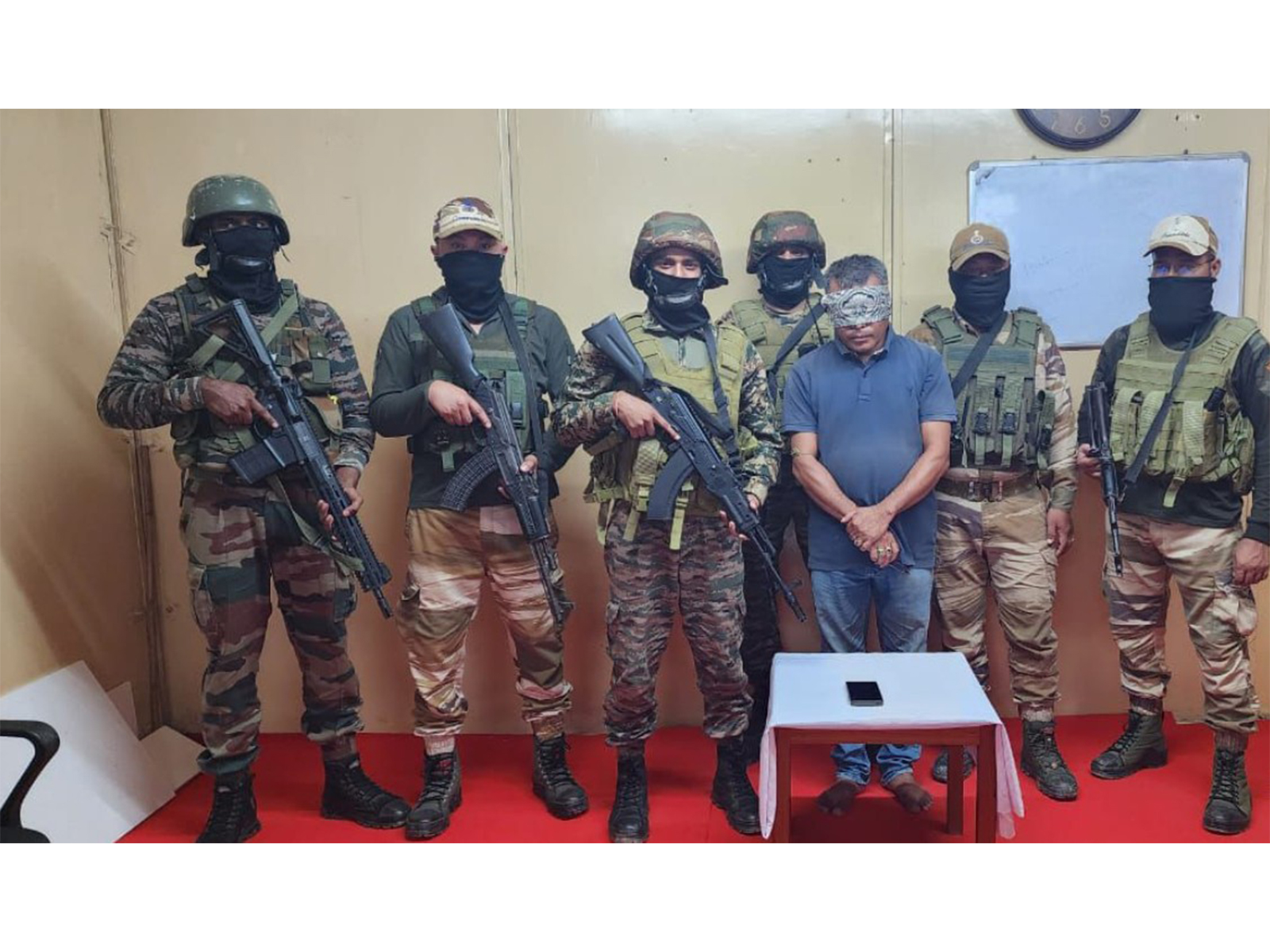 Security forces with an arrested cadre. (Photo/ANI)