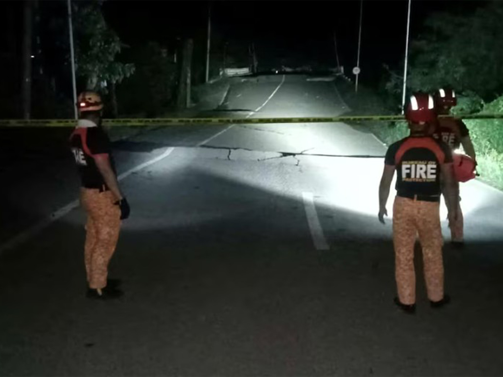 Rescue personnel stand in front of a damaged road after the earthquake (Photo/ Reuters)