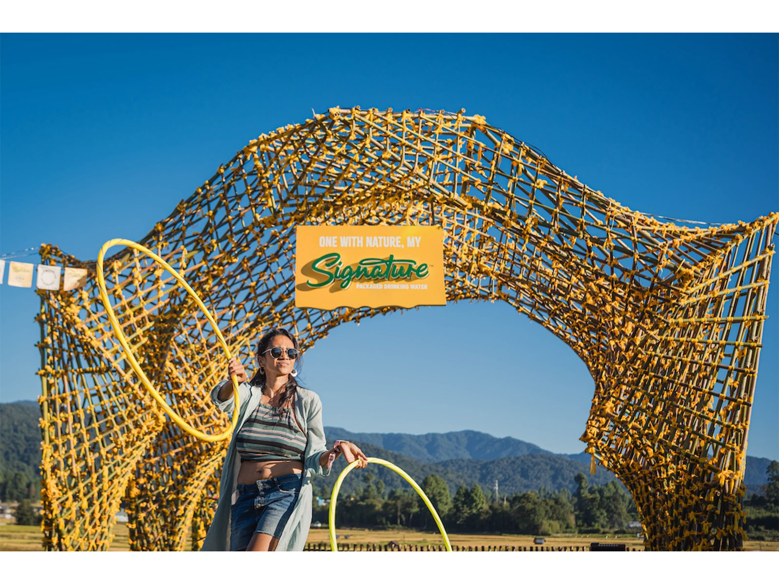 The image shows a facilitator leading the Signature Masterclass on Flow State of Mind by Signature Packaged Drinking Water at the Ziro Festival