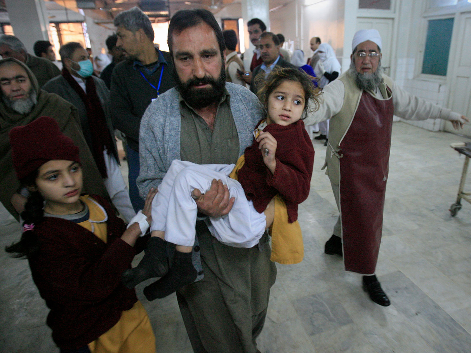 A man carries a student, who was injured during bomb blast (File Photo/Reuters) A man carries a student, who was injured during bomb blast (File Photo/Reuters)