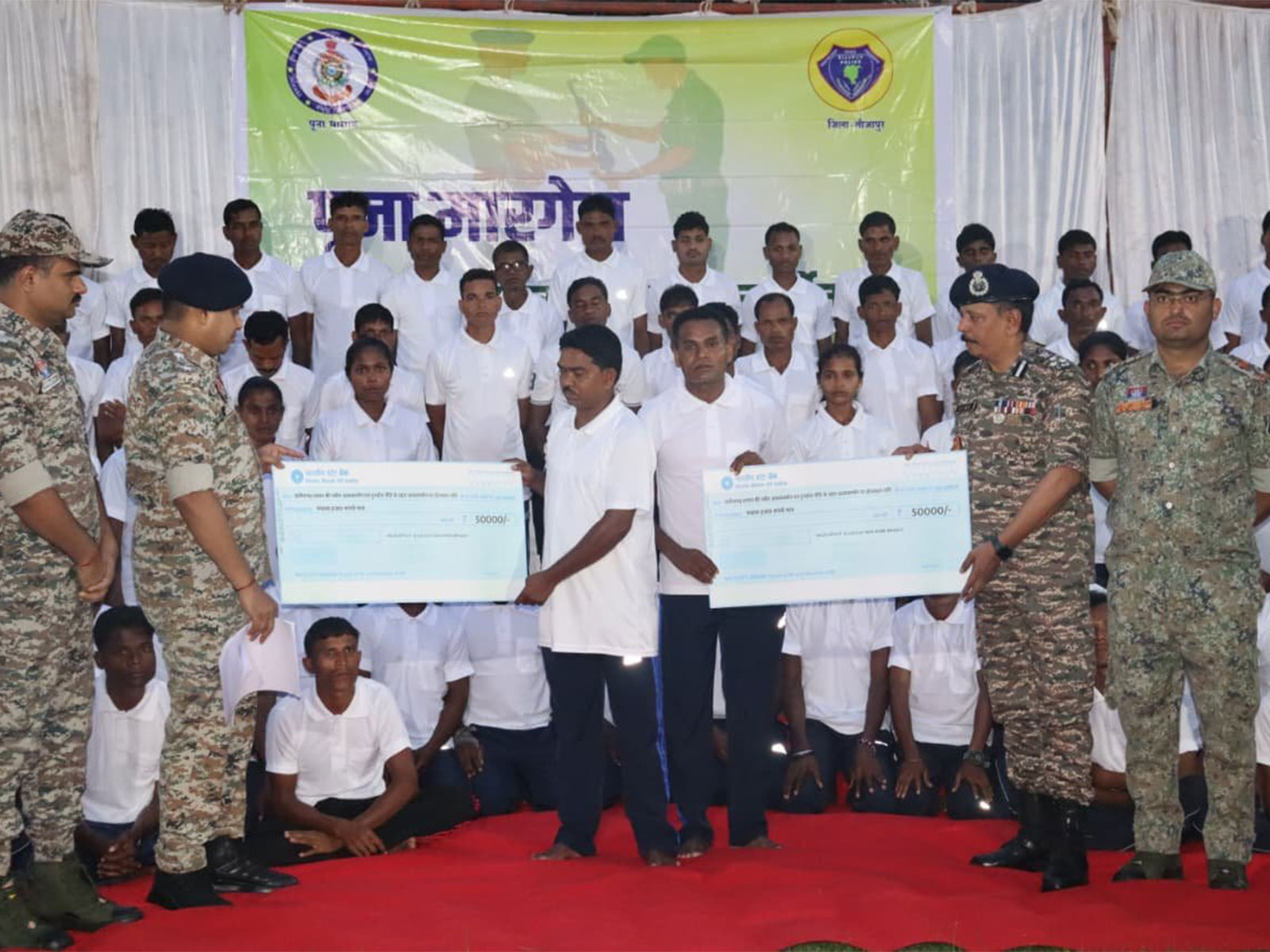 Maoists who joined mainstream society receive cheques of Rs 50,000 as incentive (Photo/ANI) Maoists who joined mainstream society receive cheques of Rs 50,000 as incentive (Photo/ANI)
