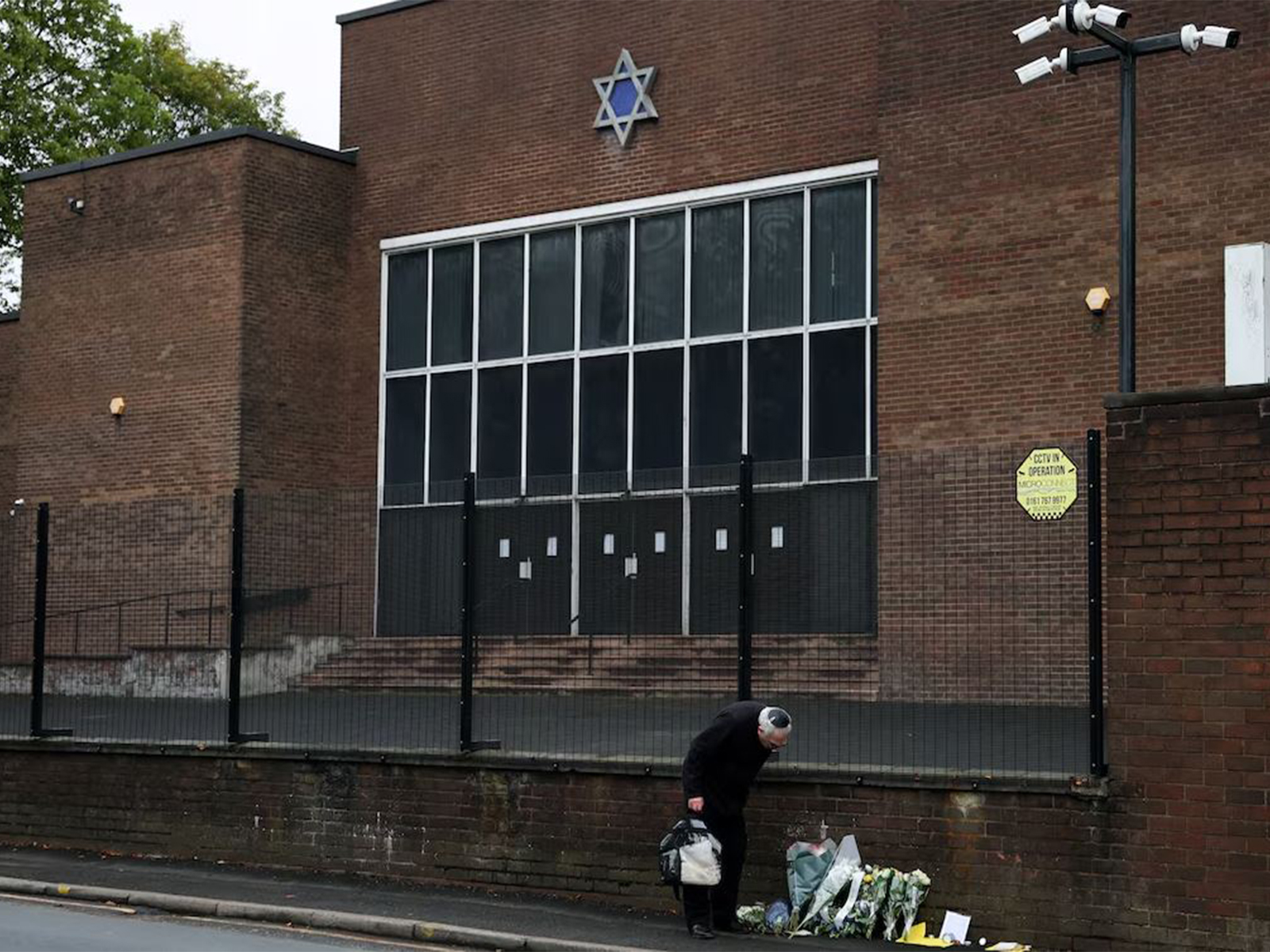 A man looks at floral tributes outside the Manchester synagogue, where multiple people were killed on Yom Kippur (Photo/Reuters) A man looks at floral tributes outside the Manchester synagogue, where multiple people were killed on Yom Kippur (Photo/Reuters)
