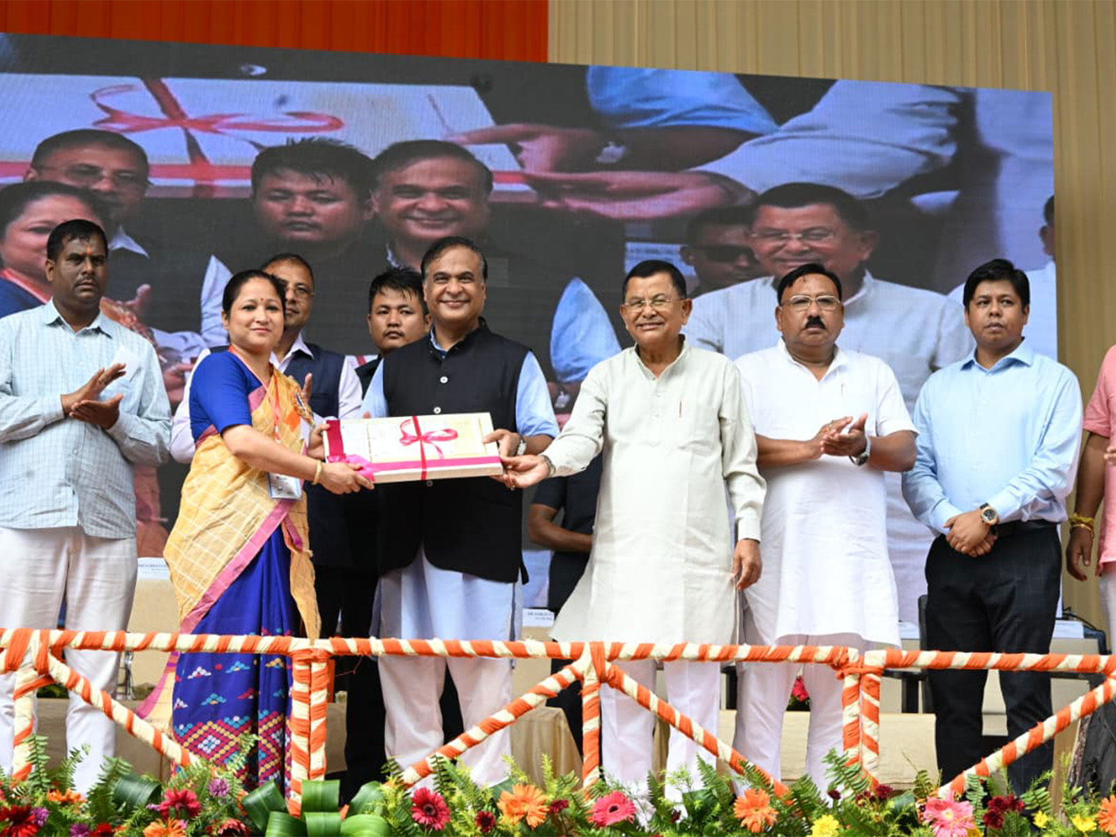 Assam CM Sarma distributes cheques to beneficiaries. (Photo/ANI)