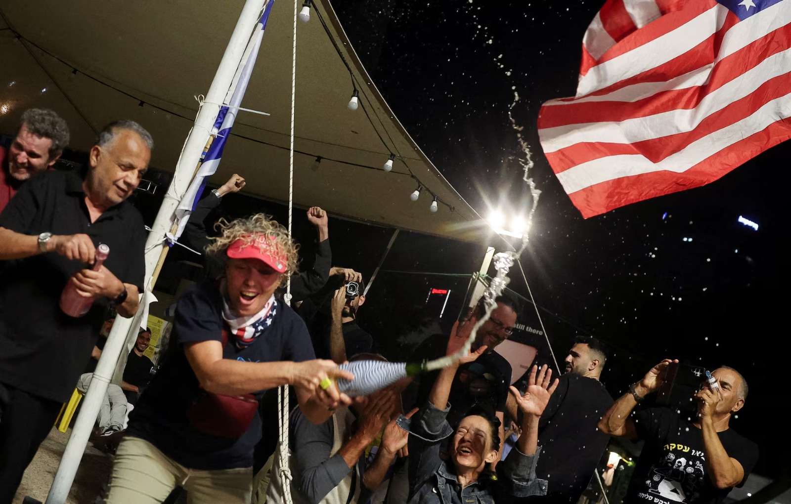 People celebrate after Israel and Hamas agreed on the first phase of a Gaza ceasefire, at the 