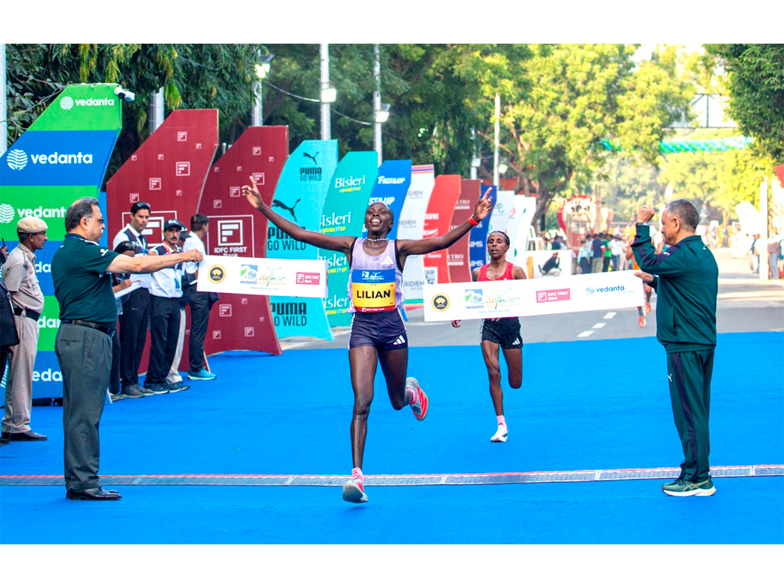 Kenya's Lilian Kasait Rengeruk crosses the finish line to claim the overall women's title at the Vedanta Delhi Half Marathon 2025, powered by adidas.
