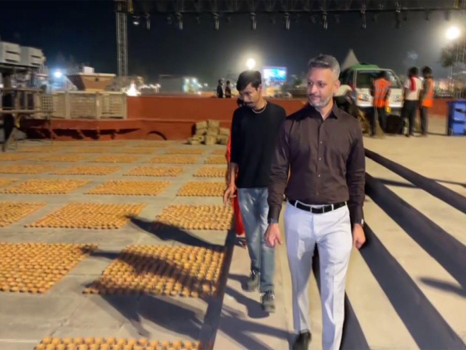 Devotees place clay lamps on the banks of the Saryu during Diwali preparations in Ayodhya