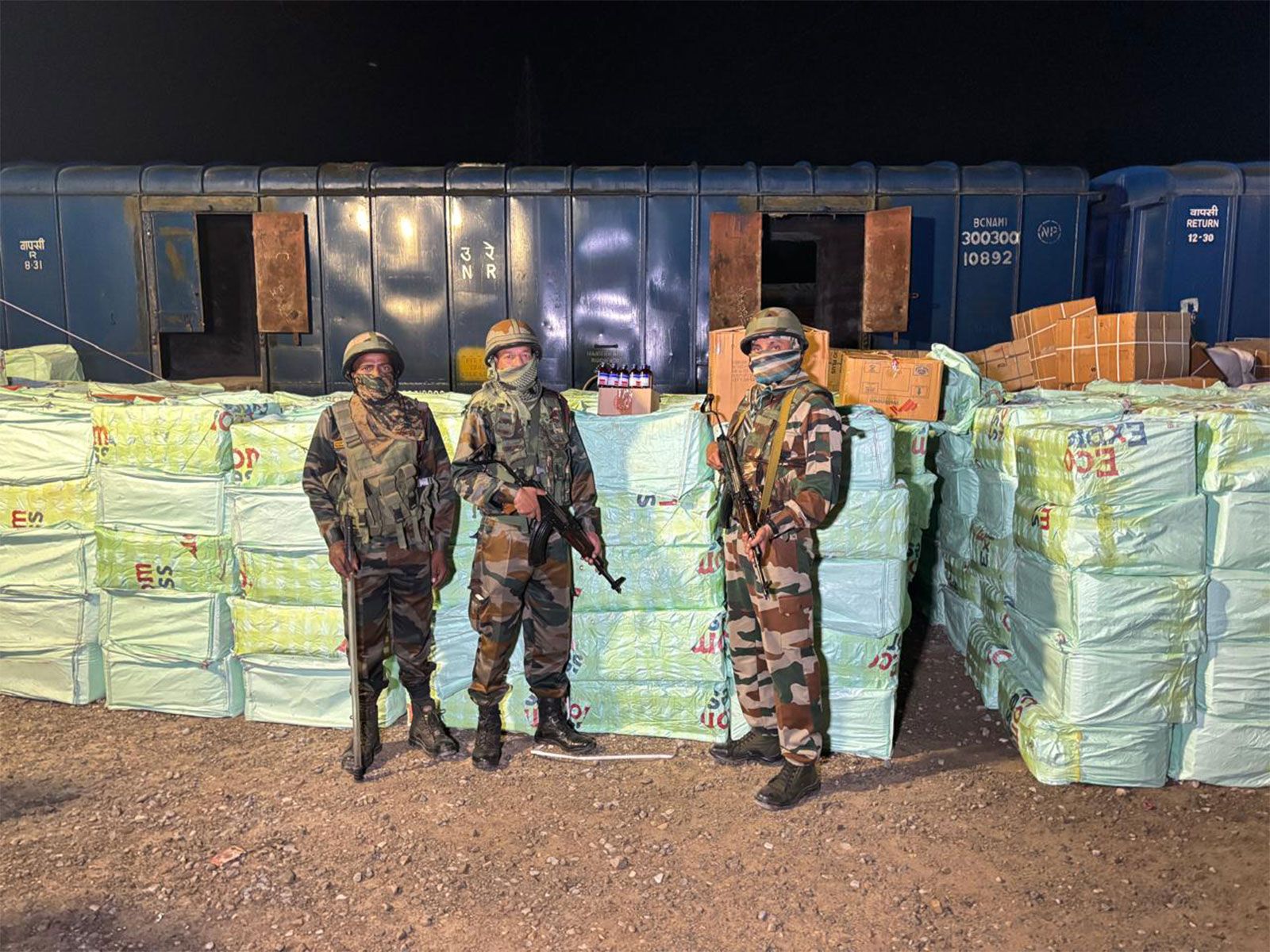 Assam Rifles with seized quantity of codeine-based syrup. (Photo/ANI)