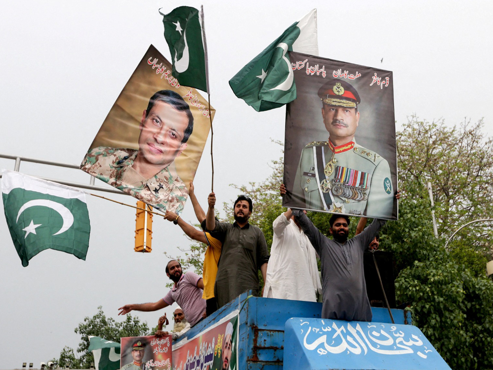 People carry posters showing the pictures of Chief of Army Staff of Pakistan Asim Munir (Photo/Reuters)