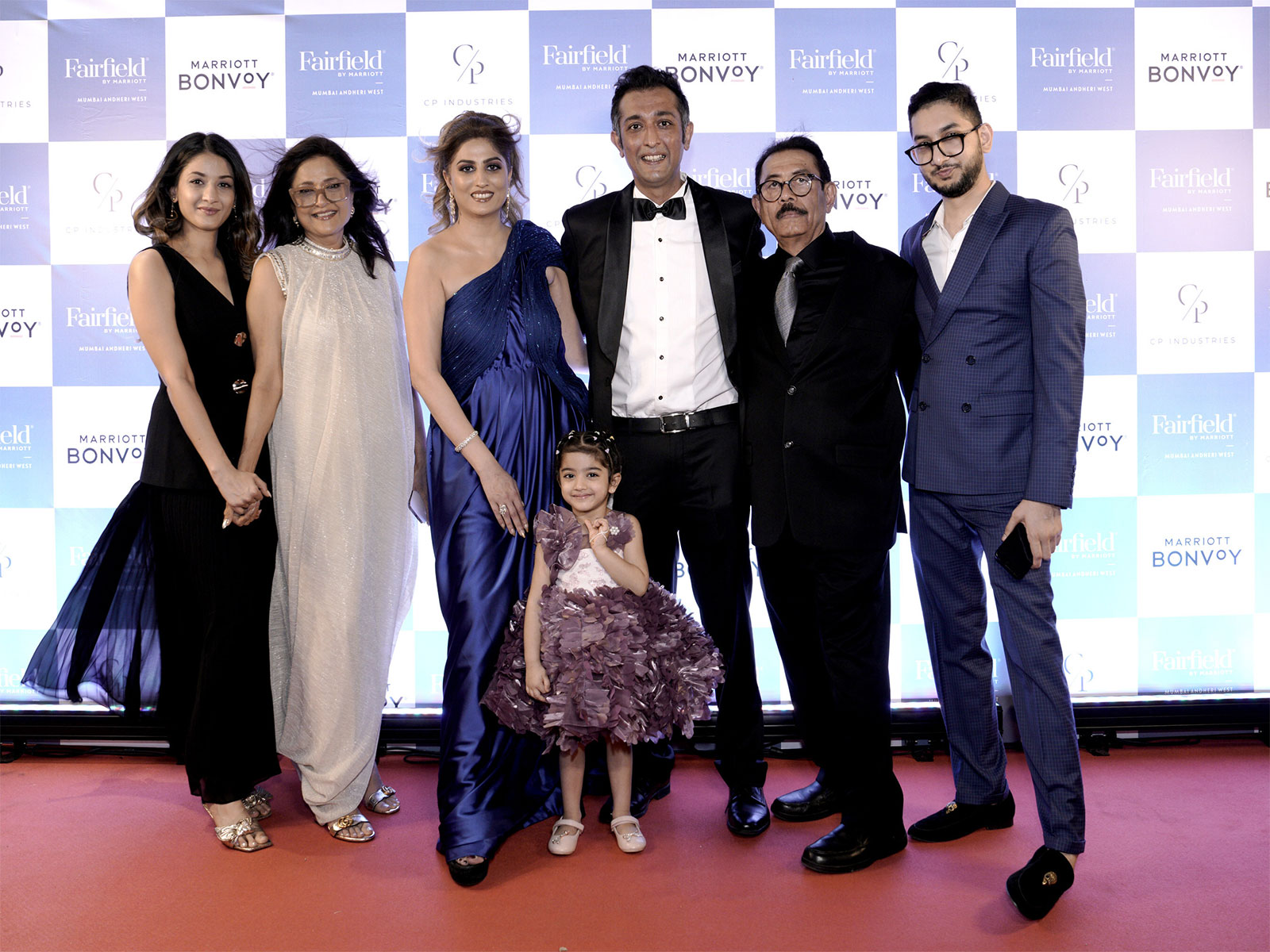 (L–R) Richa Patel, Alka Patel, Urvashi Patel, Karan Patel, Dinesh Patel, Aakash Patel, and Natali Patel (center), daughter of Karan and Urvashi Patel, at the launch event.
