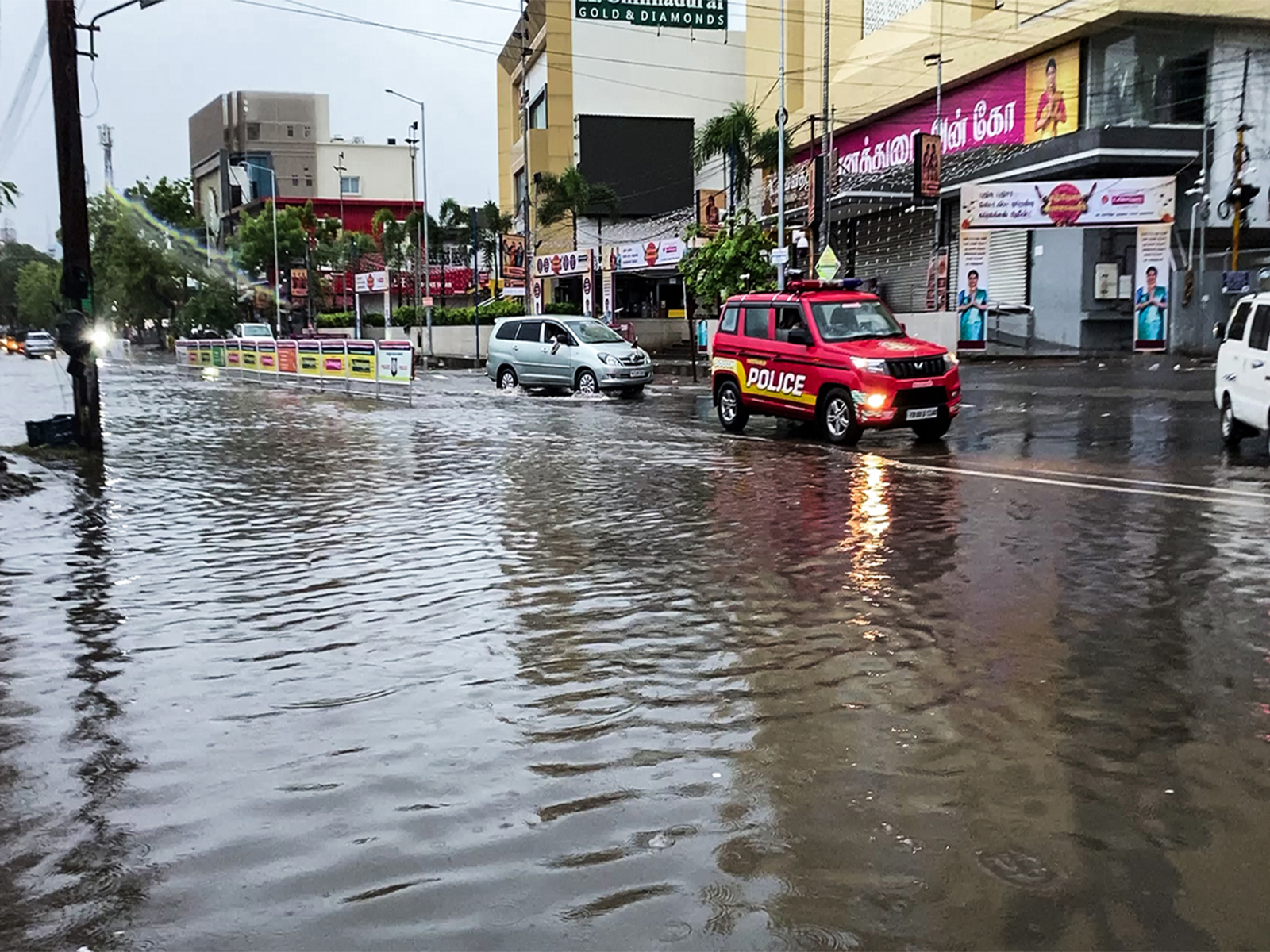 Vehicles wade through a water-logged street after heavy rainfall, in Thoothukudi on Tuesday (Photo/ANI)