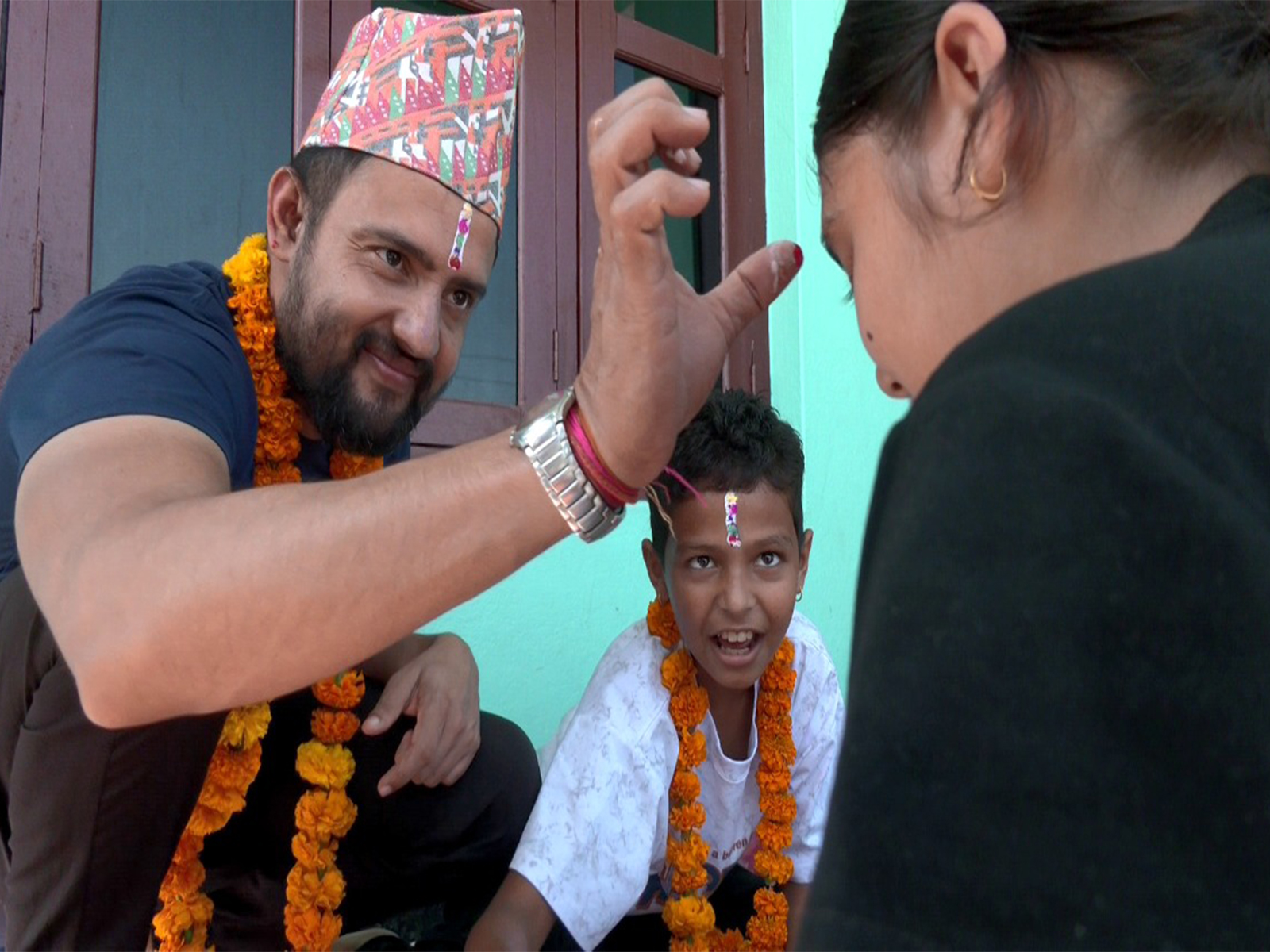 Ramesh Gautam (left) offers Tika to sister on the final day of Tihar in Bharatpur, Nepal. (Photo/ANI)