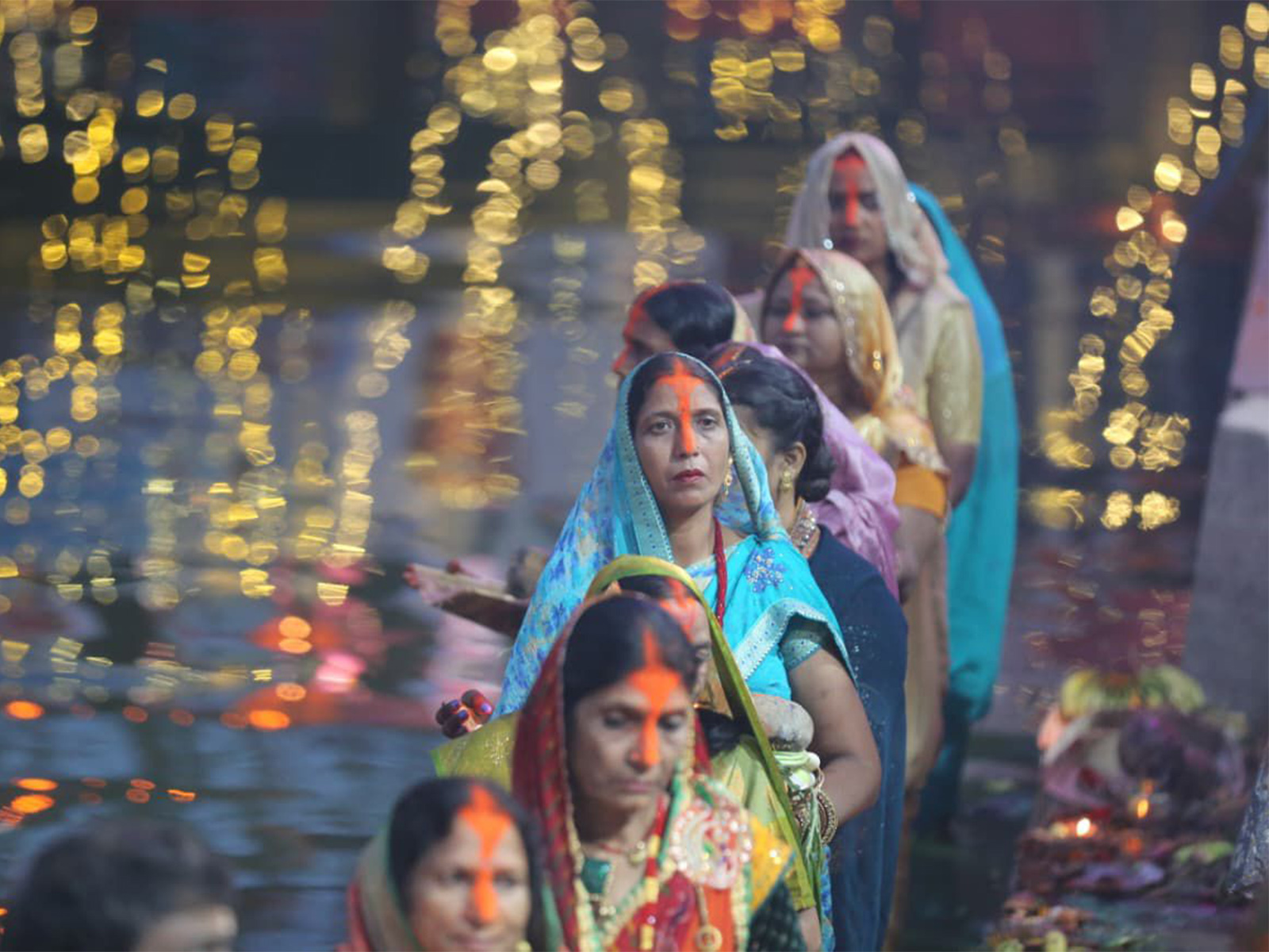 Devotees offer prayers to the rising sun during Chhath celebrations in Birgunj, Nepal. (Photo/ANI)