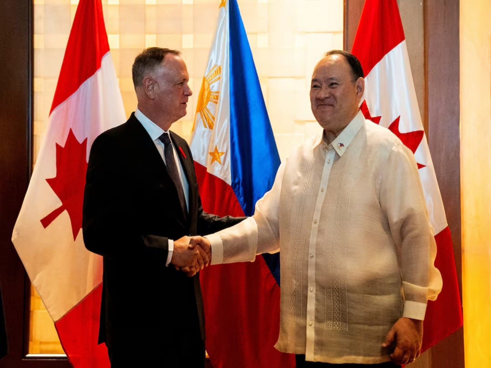 Canada’s Defence Minister David McGuinty shakes hands with Philippine Defence Secretary Gilberto Teodoro Jr before their bilateral meeting in Makati City, Metro Manila, Philippines. (Photo/Reuters)