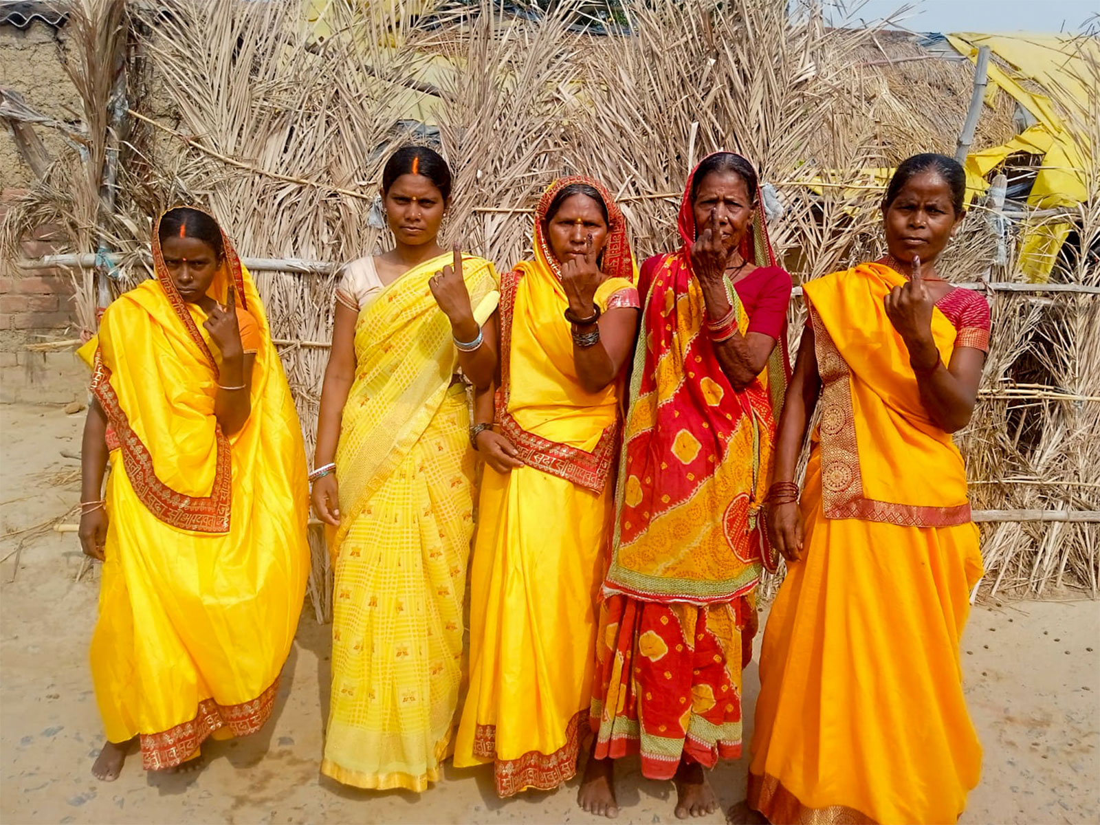 Voters show their ink-marked fingers after casting their votes. (Photo/ANI)