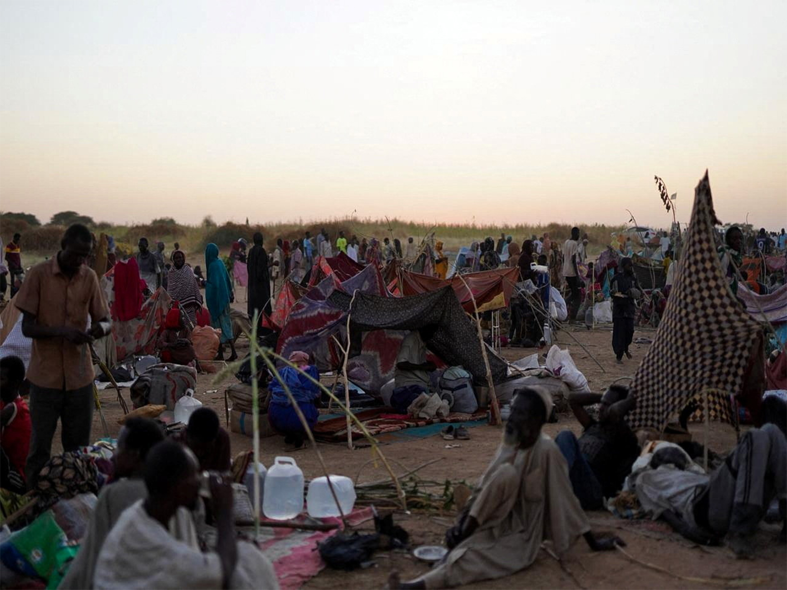 A general view of people sitting at a camp for displaced families who fled from al-Fashir to Tawila, North Darfur (Photo/Reuters)