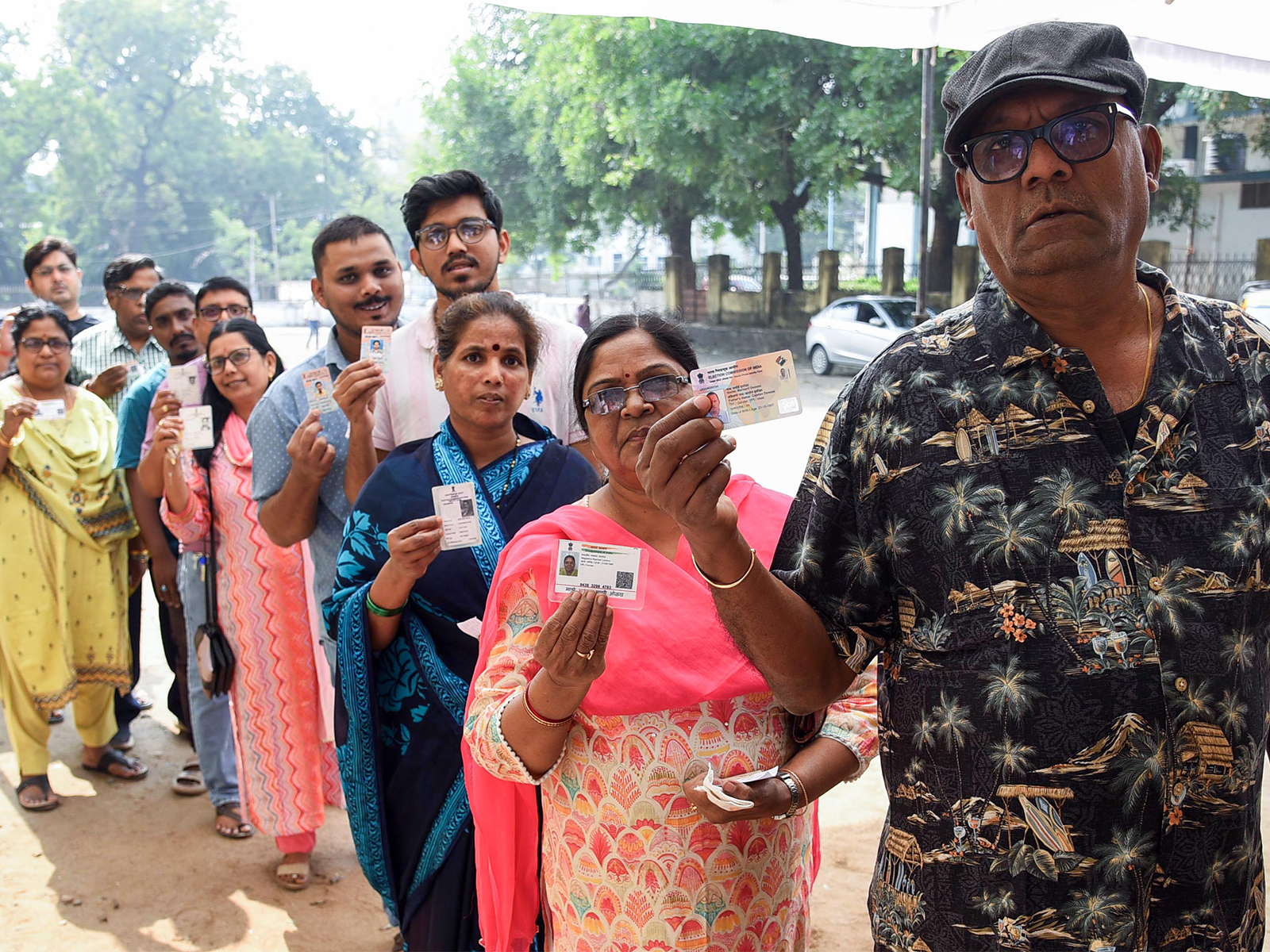 Voters show their IDs while waiting in a queue to cast their vote (Representational Image/ANI)