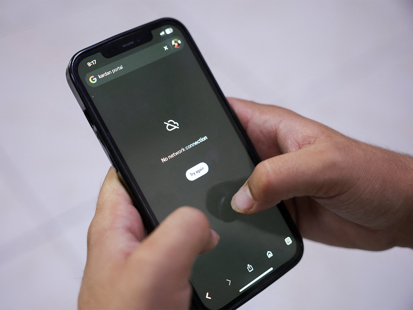 A man attempts to access Google on his smartphone during a nationwide telecom shutdown, in Kabul, Afghanistan. (Photo/Reuters)