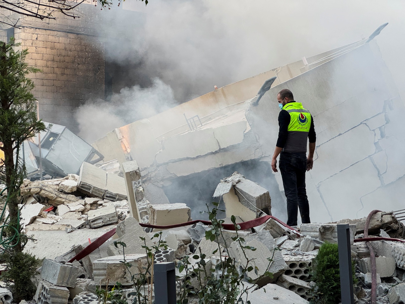 A civil defence member stands on rubble at a damaged site after Israeli military strike in Lebanon (File Photo/ Reuters)