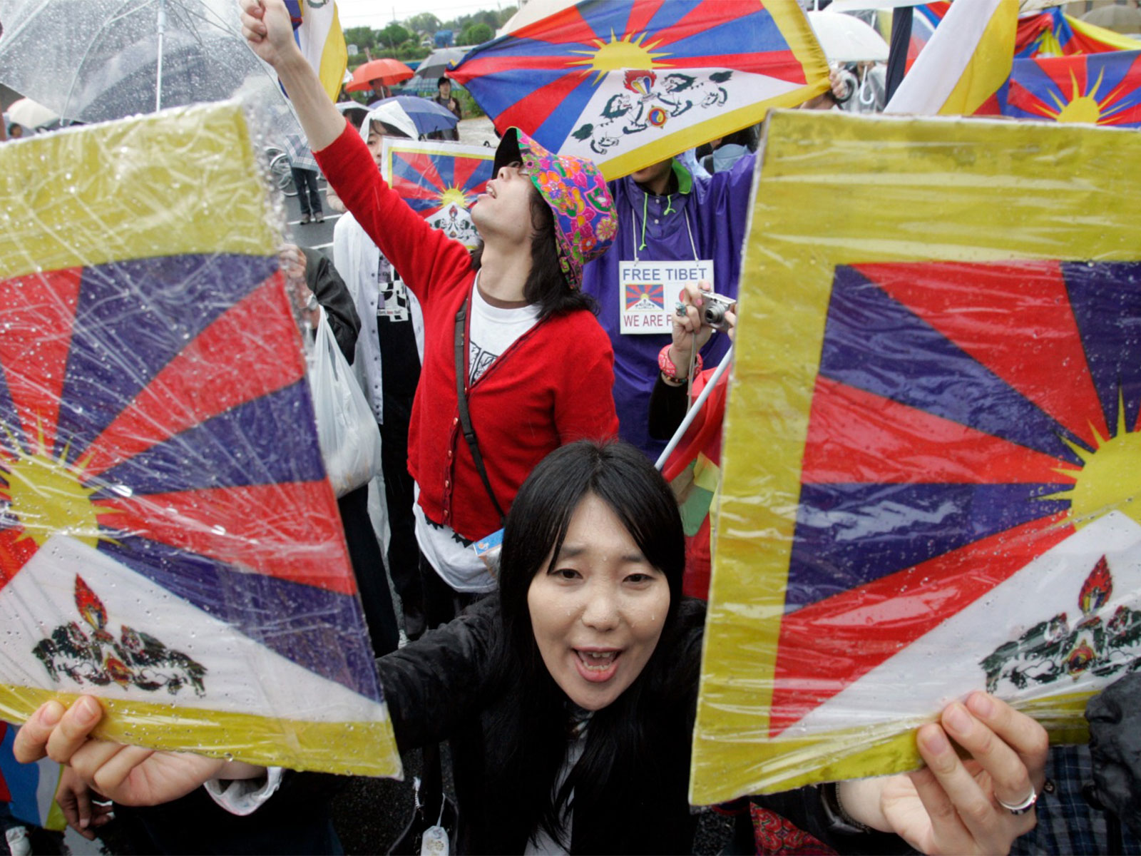 A pro-Tibet supporter holds placards displaying Tibetan flags during a demonstration in Japan (File Photo/ Reuters) A pro-Tibet supporter holds placards displaying Tibetan flags during a demonstration in Japan (File Photo/ Reuters)