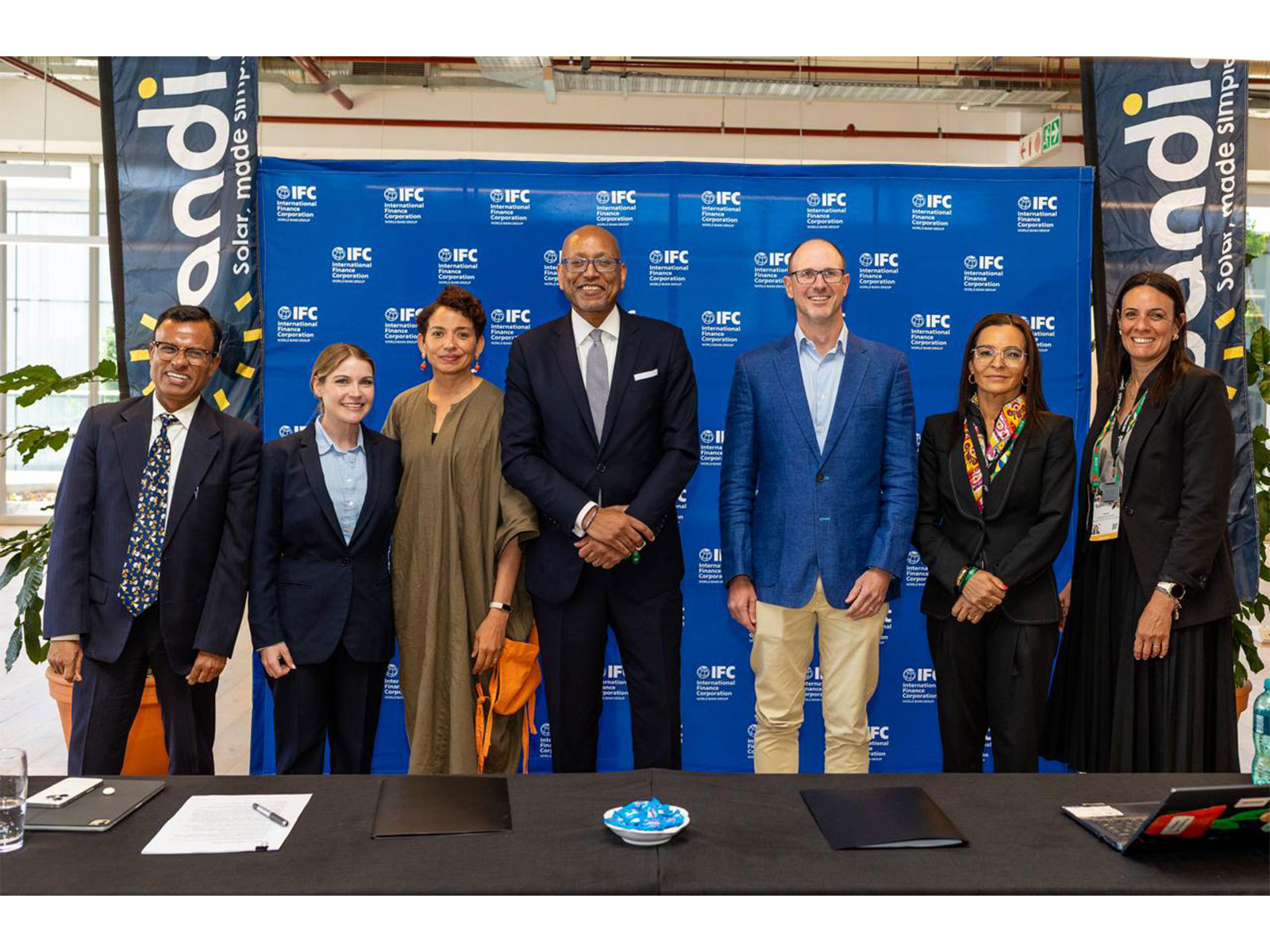From left to right: Pranab Ghosh, Jade Adair, Heidi Akran, Ethiopis Tafara, Phi lipe Flamand, Claudia Conceicao, and Amina El Zayat at the IFC & Candi Solar signing ceremony