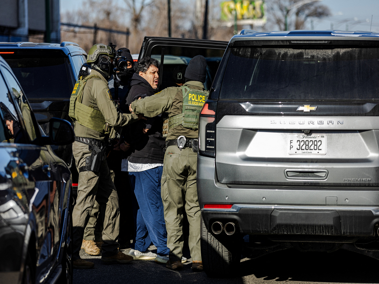 US federal agents detain a man during an immigration raid (Photo/Reuters)