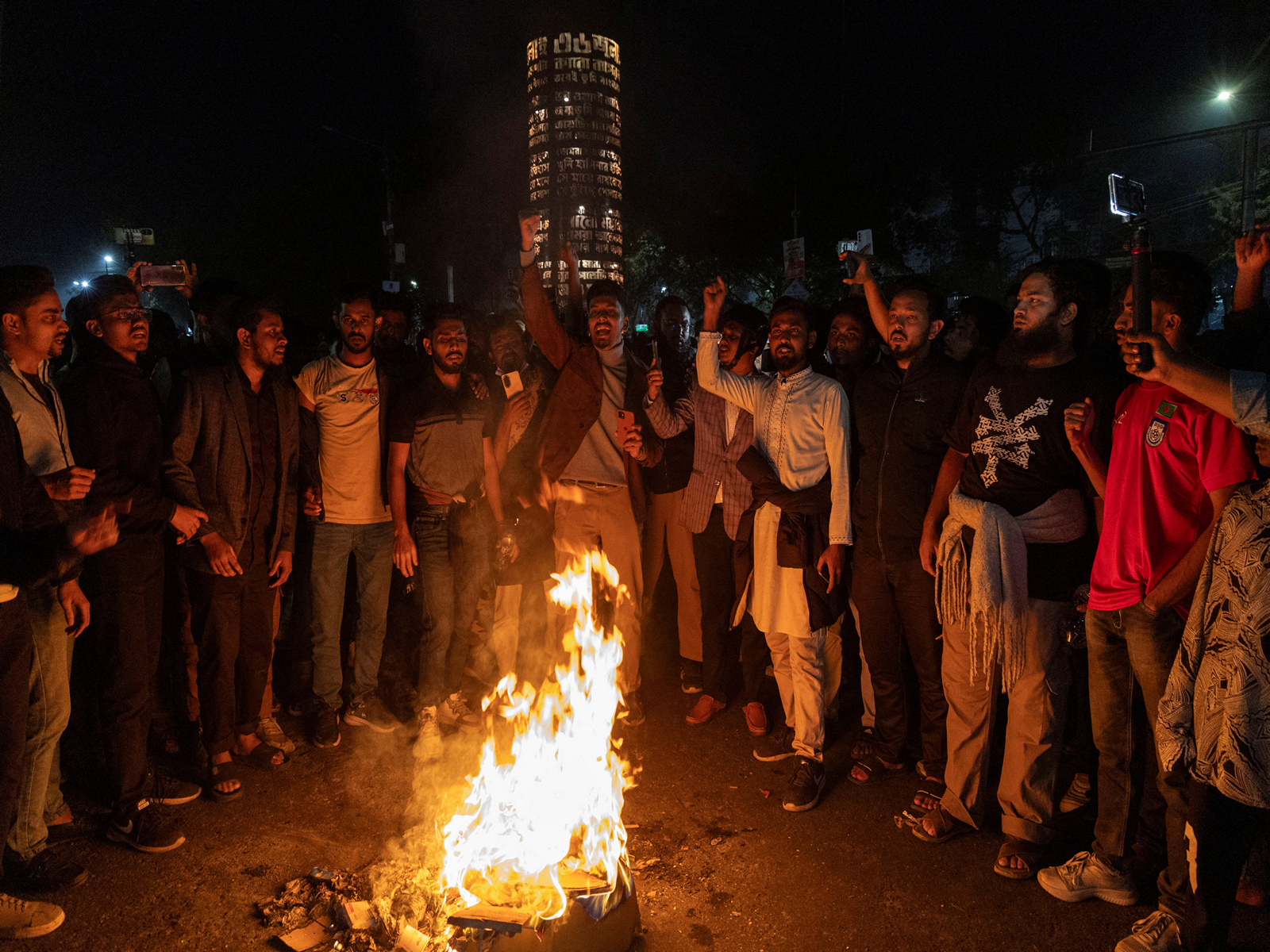 People shout slogans following the death of Sharif Osman Hadi, a student leader who had been receiving treatment in Singapore after being shot in the head (Photo/Reuters)
