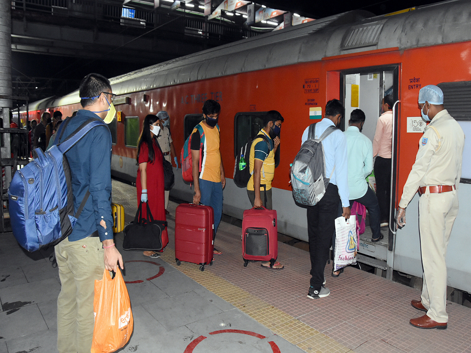 Passengers board the special train for New Delhi. (Photo/ANI)