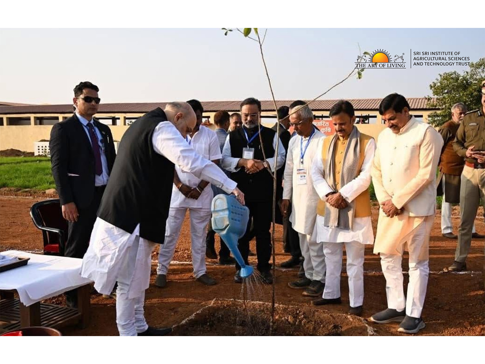 Hon’ble Union Home Minister Shri Amit Shah planting and watering a sapling at the Rewa Model Farm