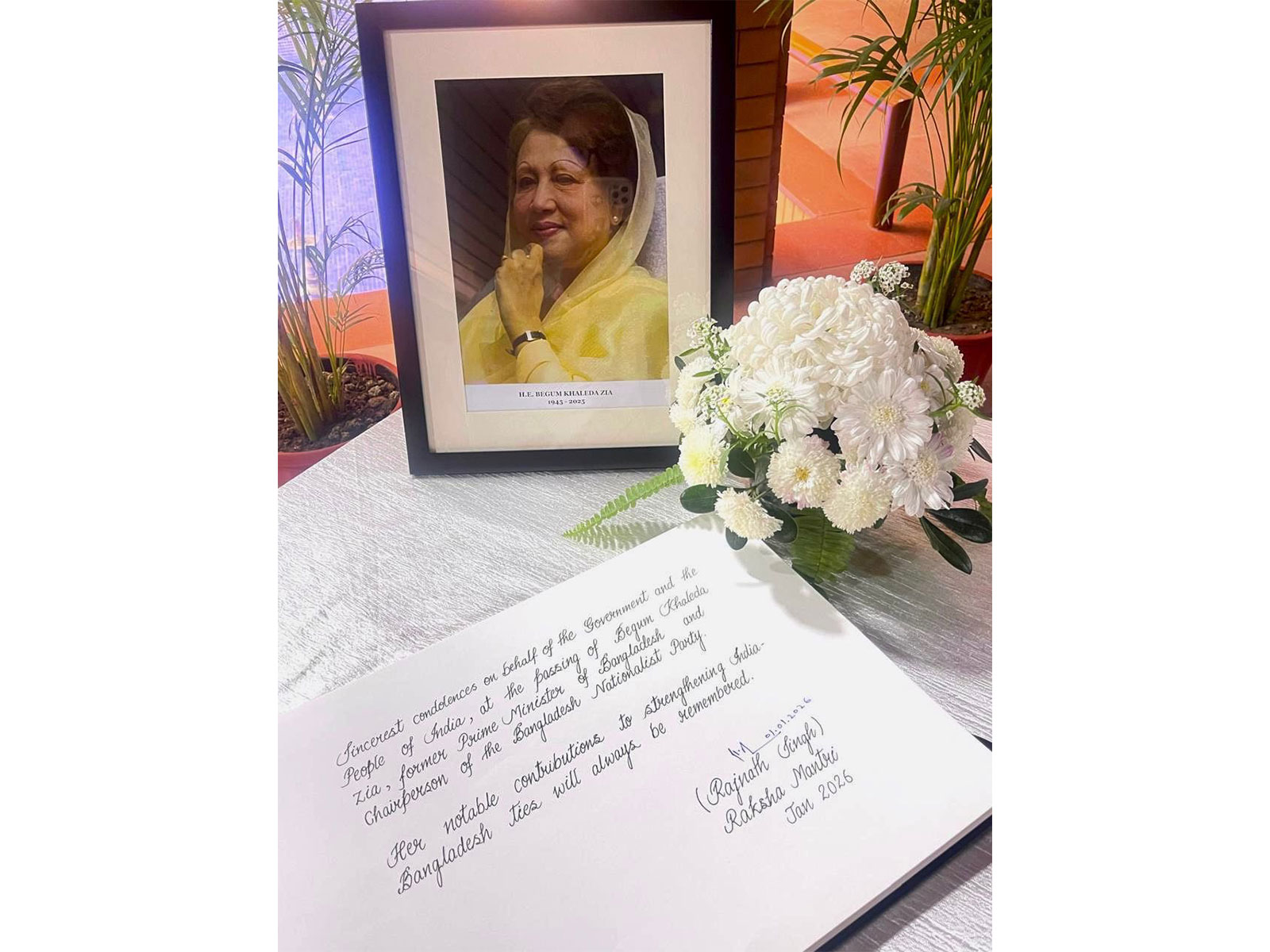 A condolence book bearing a message from Defence Minister Rajnath Singh placed beside a portrait of former Bangladesh prime minister Begum Khaleda Zia at the High Commission of Bangladesh in New Delhi. (Photo: X/@hamidullah_riaz)