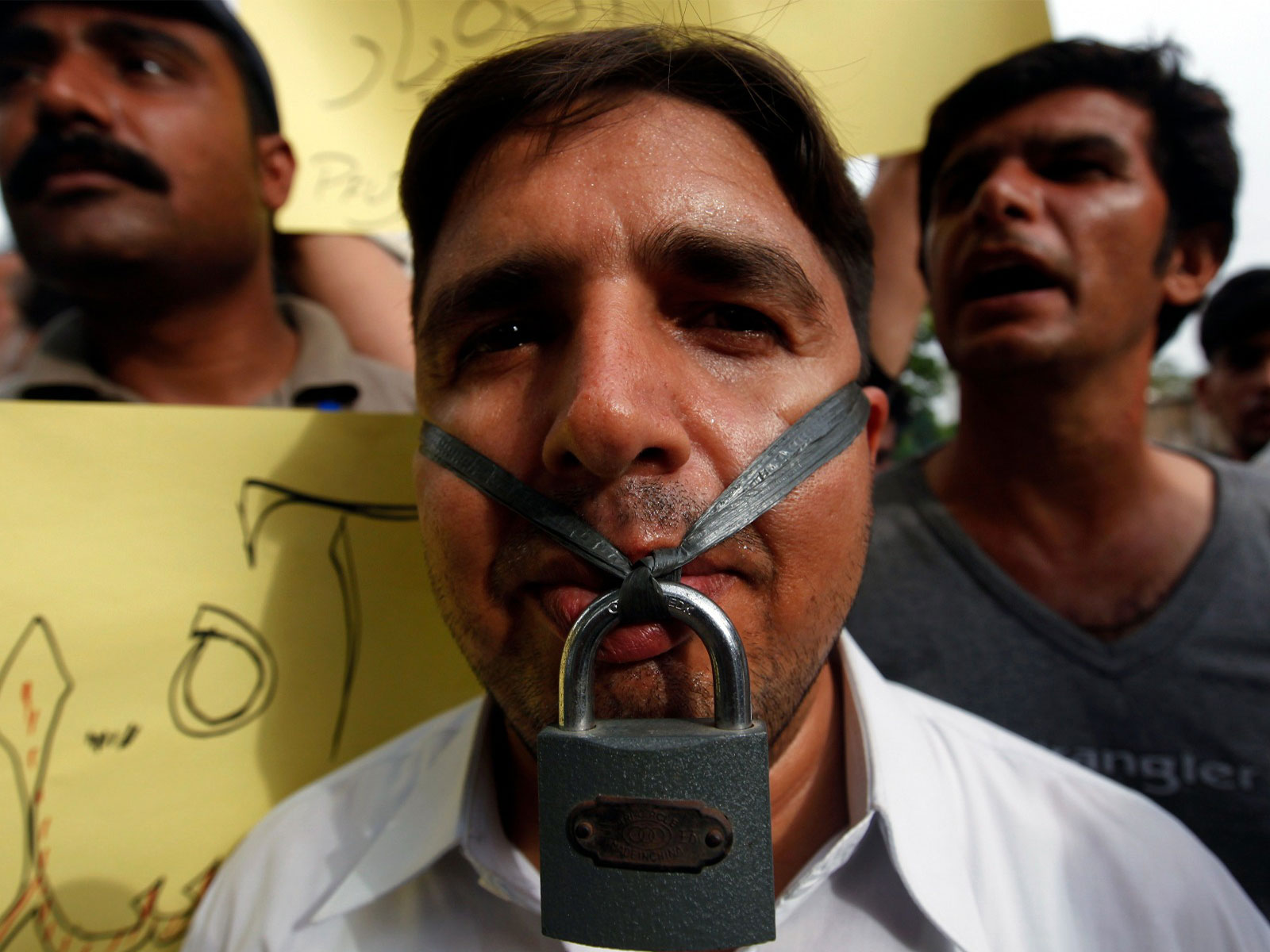 A journalist hangs a lock across his lips during a protest against the freedom of press in Karachi (File Photo/ Reuters) A journalist hangs a lock across his lips during a protest against the freedom of press in Karachi (File Photo/ Reuters)