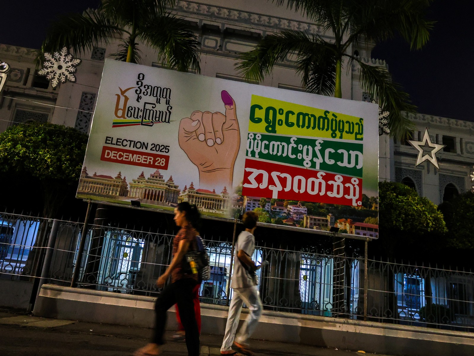 People walk past an election banner ahead of a general election in Thingangyun Township, Yangon, Myanmar (Photo/Reuters)
