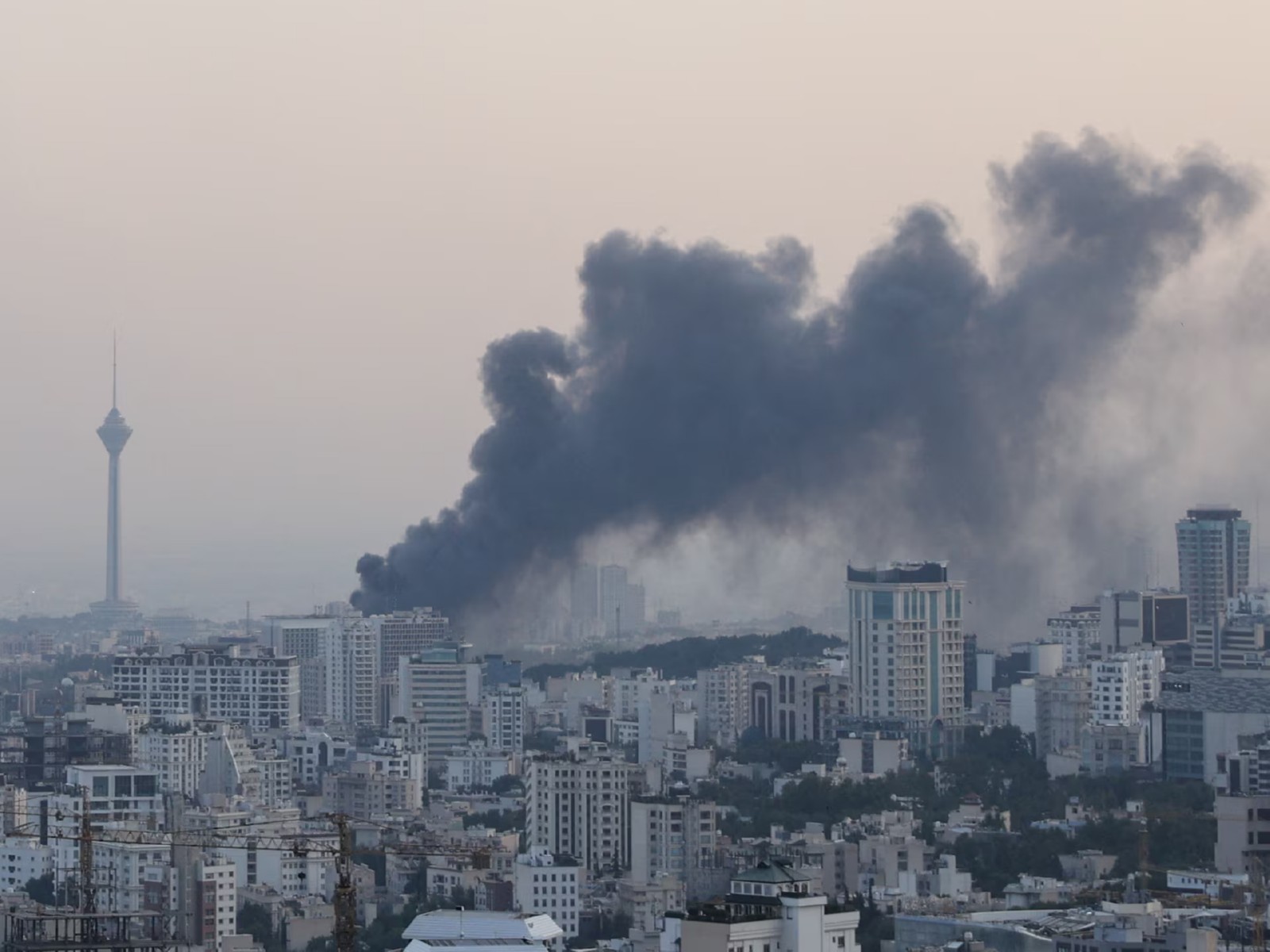 Smoke billows over Tehran after an Israeli attack in Iran (File Photo/Reuters)