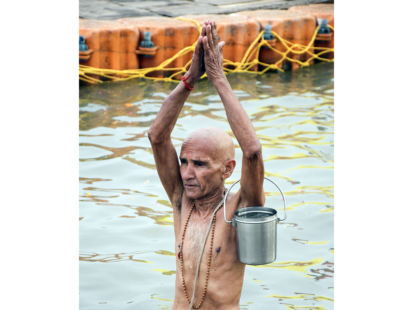 A devotee takes a holy dip ahead of Magh Mela at Sangam, in Prayagraj (File Photo/ANI)