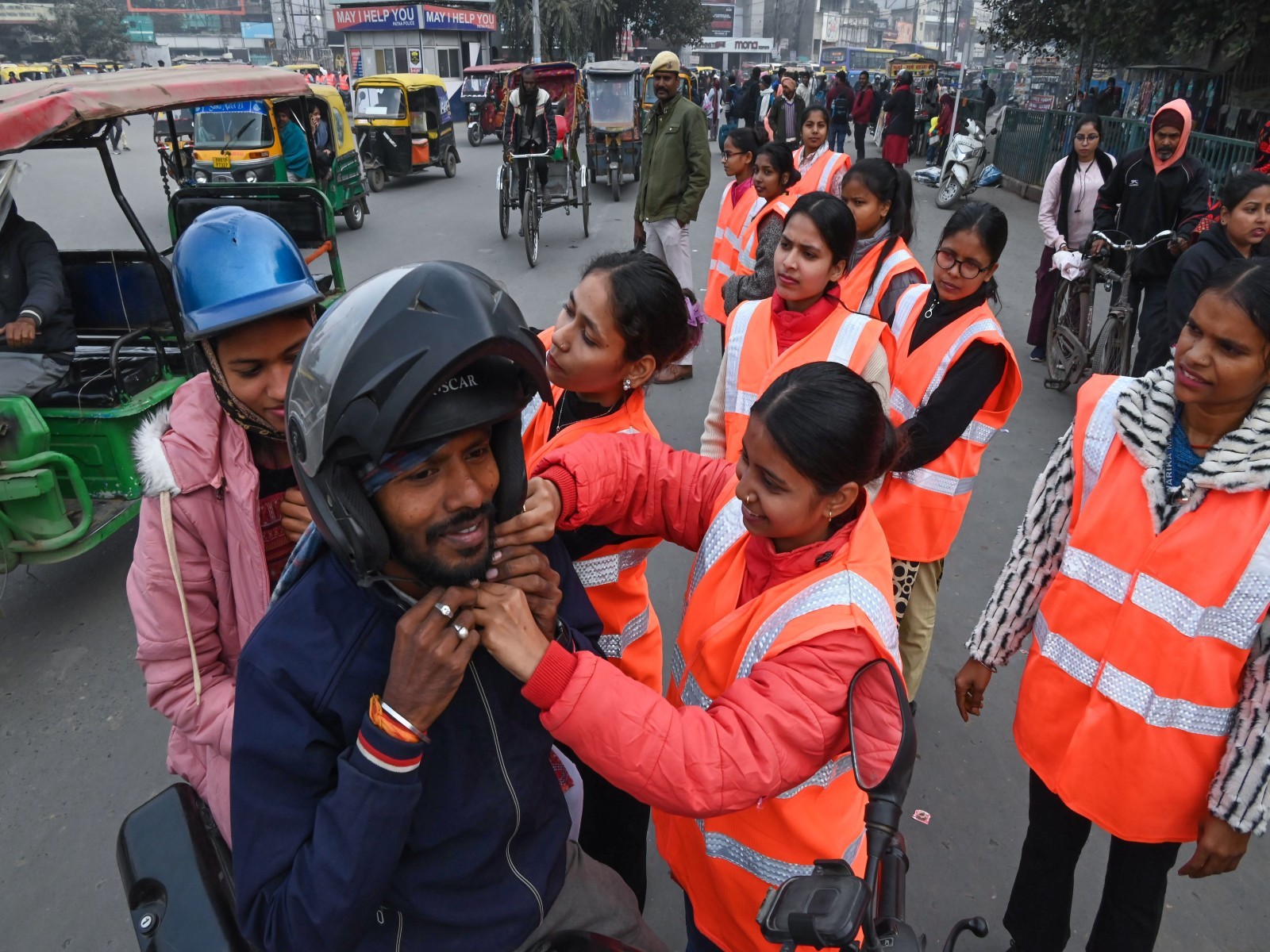 Community of traffic police put helmets on people on a bike to create awareness about traffic rules and road safety (File Photo/ANI)