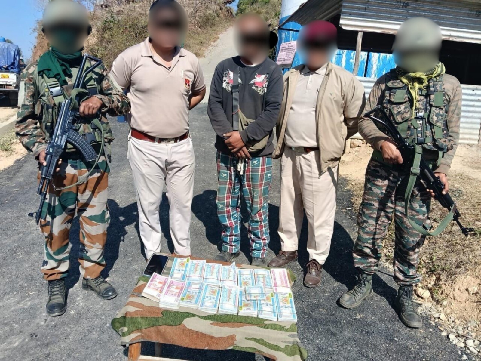 Assam Rifles with the apprehended person (centre). (Photo/@official_dgar)