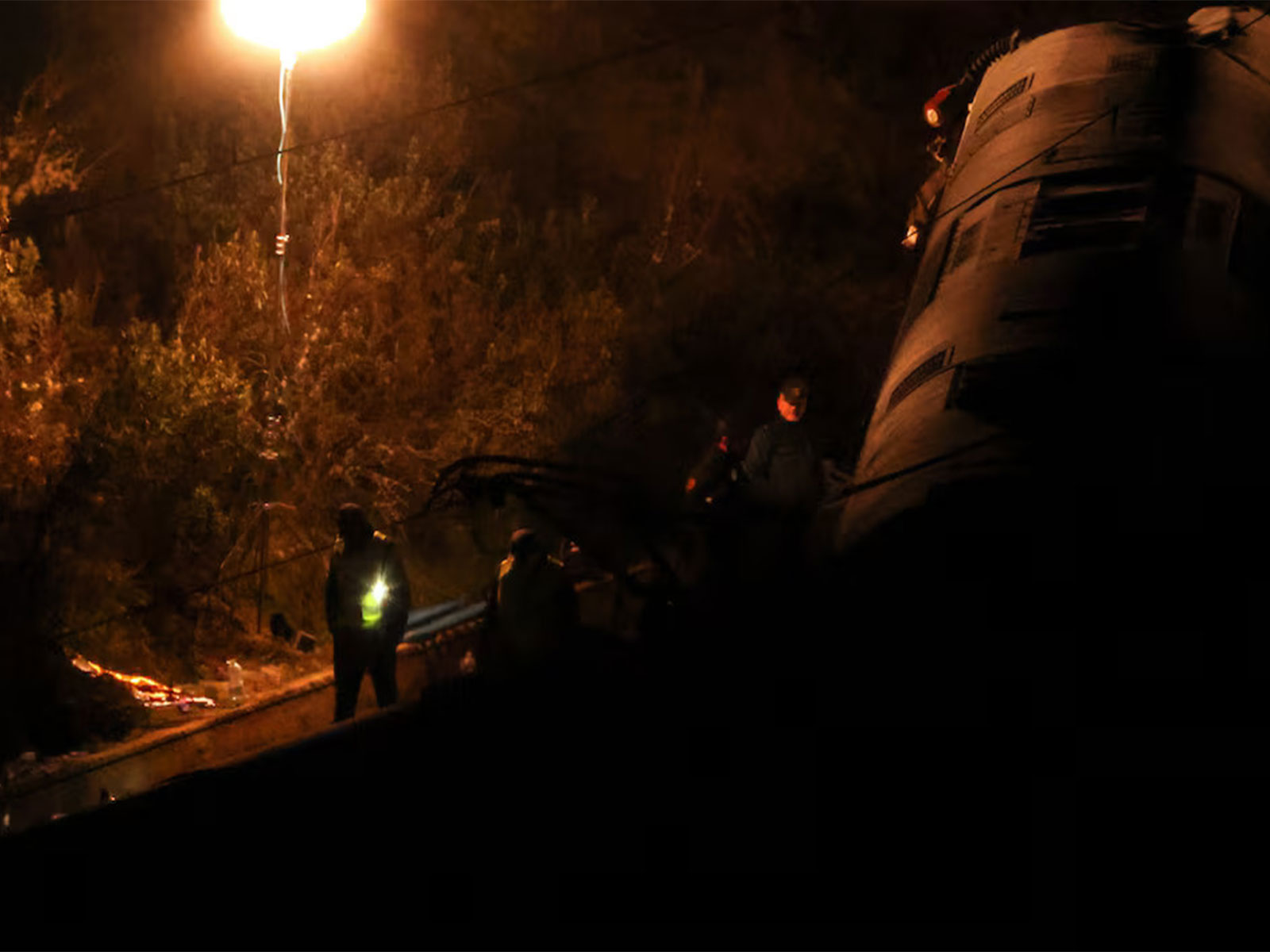 Emergency personnel work near a derailed coach at the site of the fatal high-speed train crash near Adamuz in Cordoba, Spain. (Photo/Reuters)