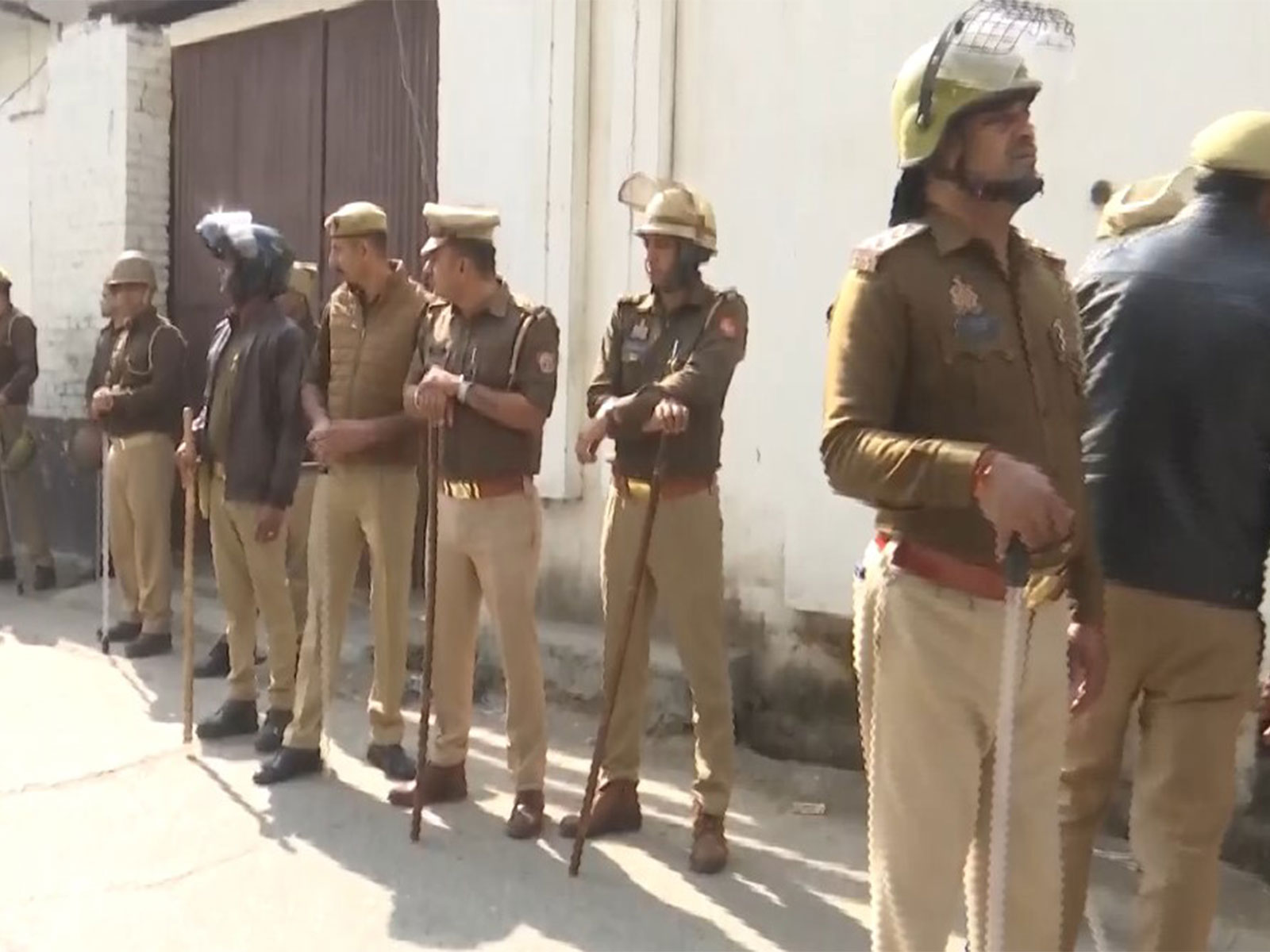 Police officials outside the house of Sharik Satha in Sambhal. (Photo/ANI)