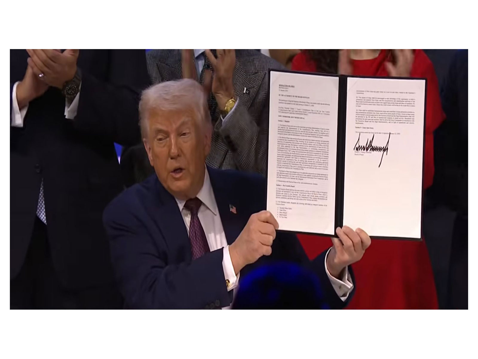 US President Donald Trump signs the charter to formally launch the 