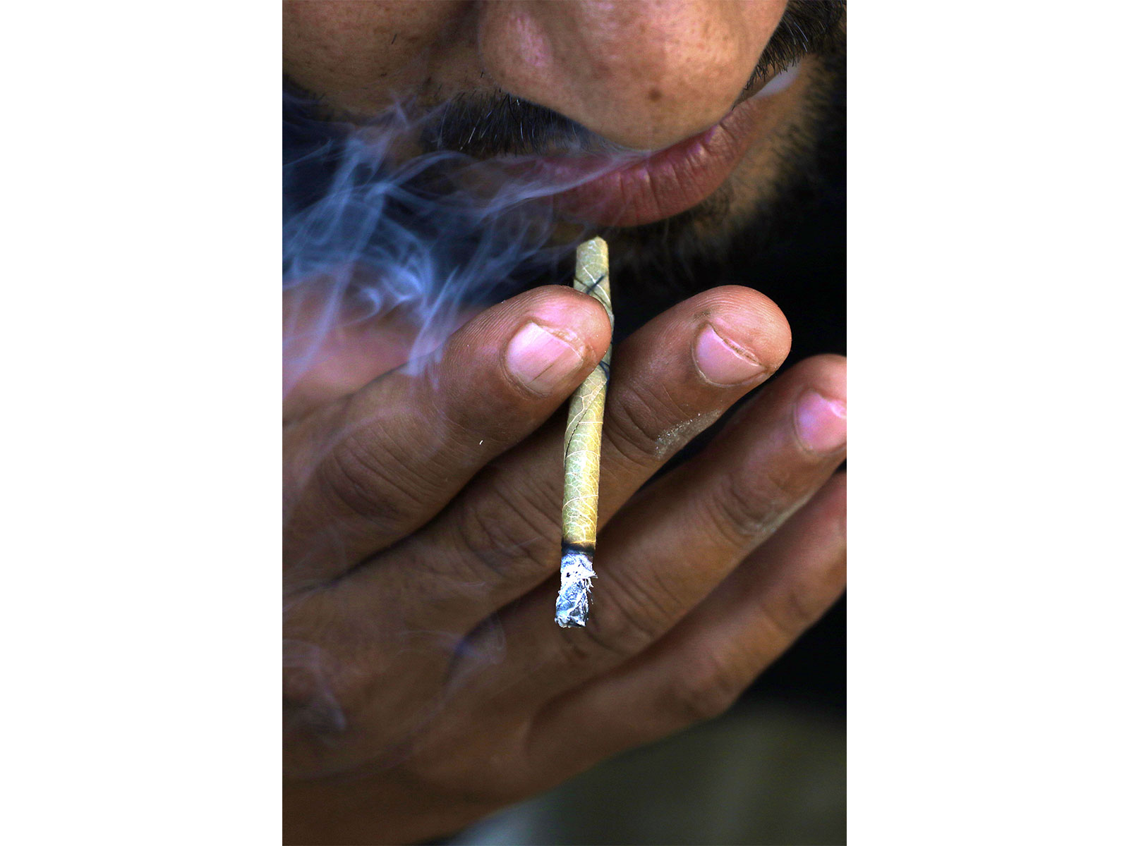 A man smokes 'Bidi', a small hand-rolled cigarette (File Photo/ANI)