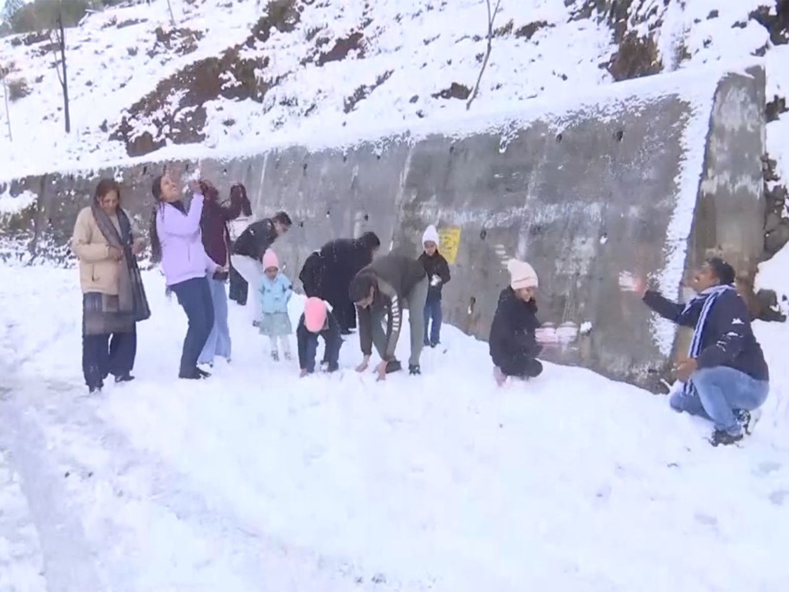 Tourists enjoying snow as Rajouri, Jammu and Kashmir (Photo/ANI)