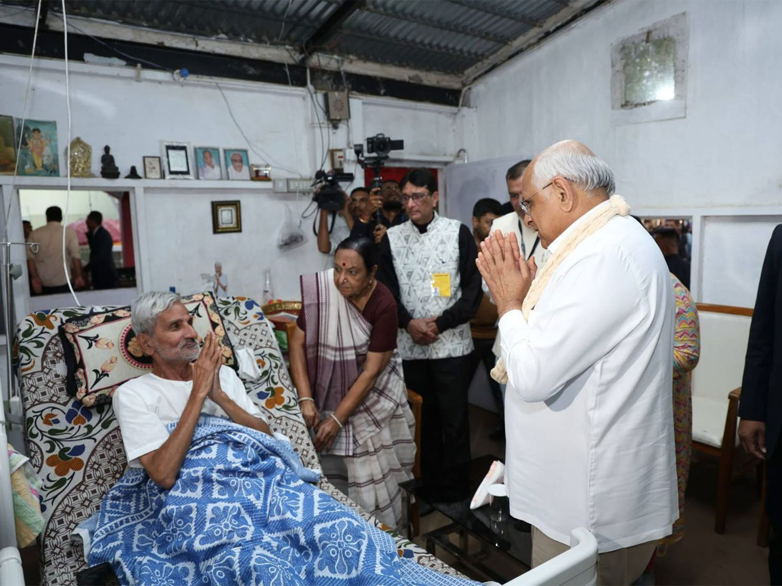 Gujarat Chief Minister Bhupender  Patel with a Leprosy patient (Photo/ANI)